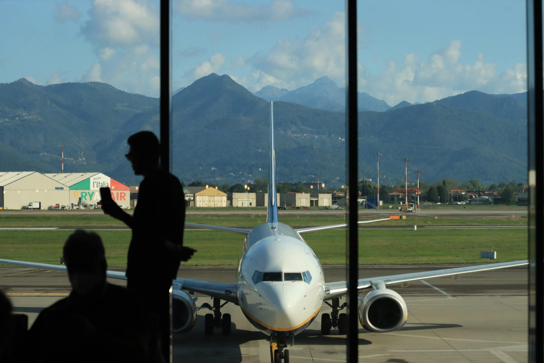 Traveler silhouette near an airport window