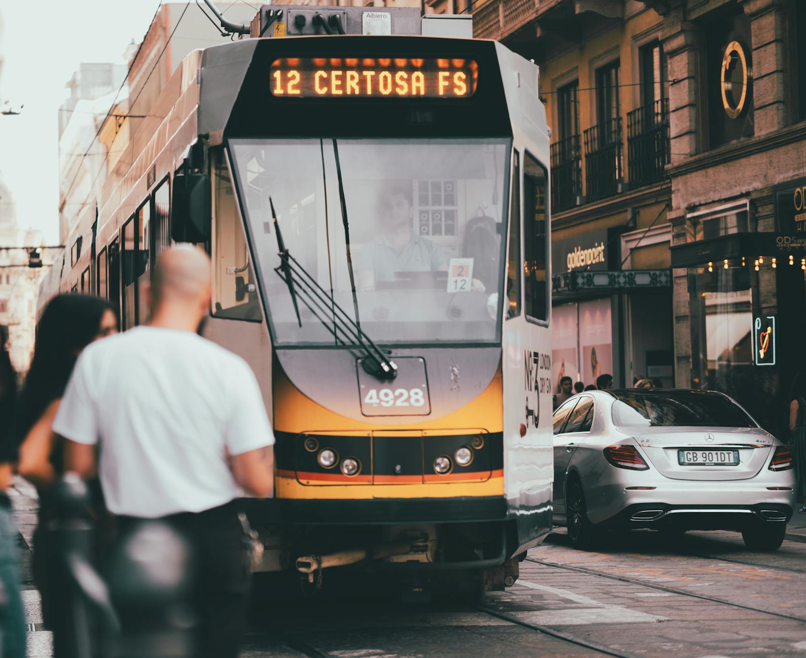Busy Milan street scene with tram