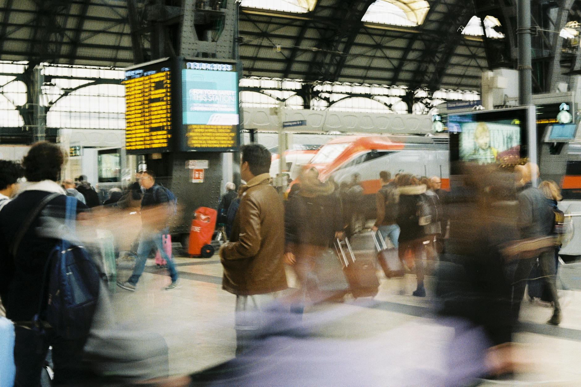 Passengers moving through a Milan train station