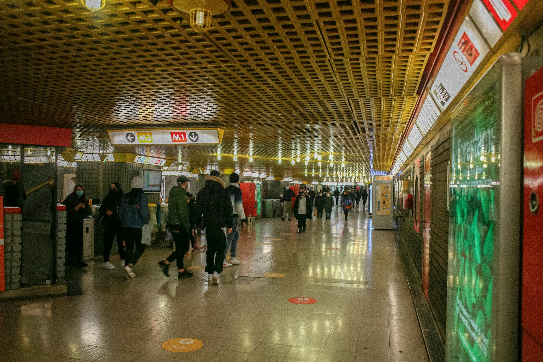 People walking through a Milan metro station