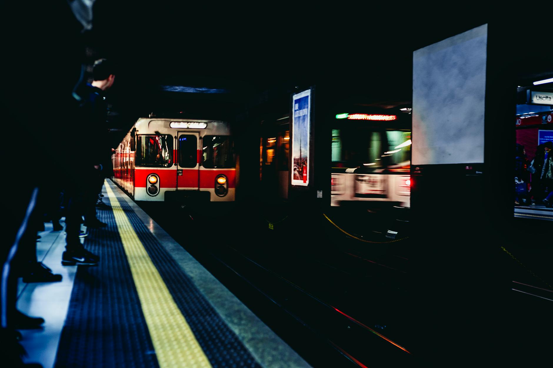 Train arriving at a Milan subway station at night