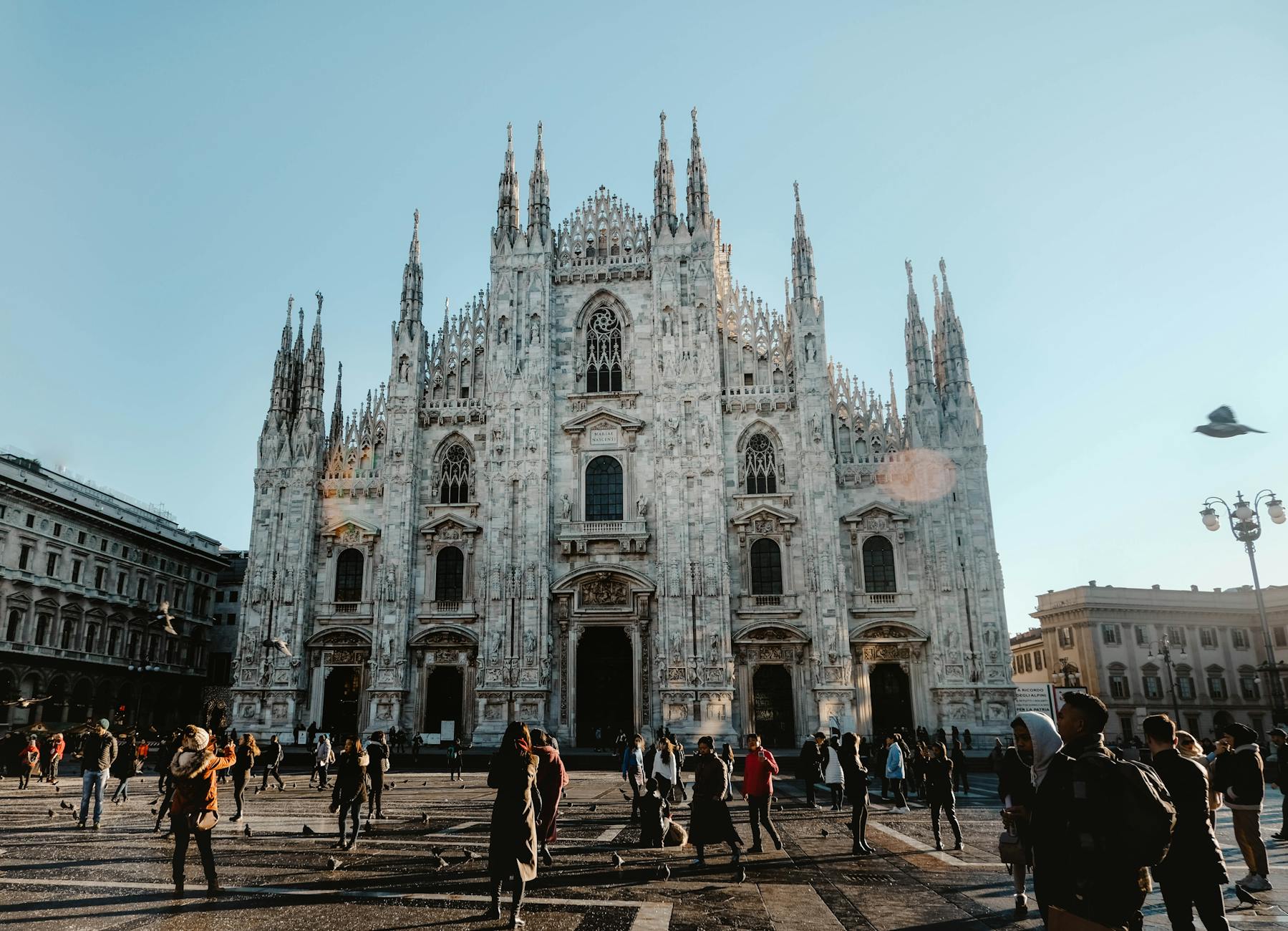 People walking in front of a white building in Milan