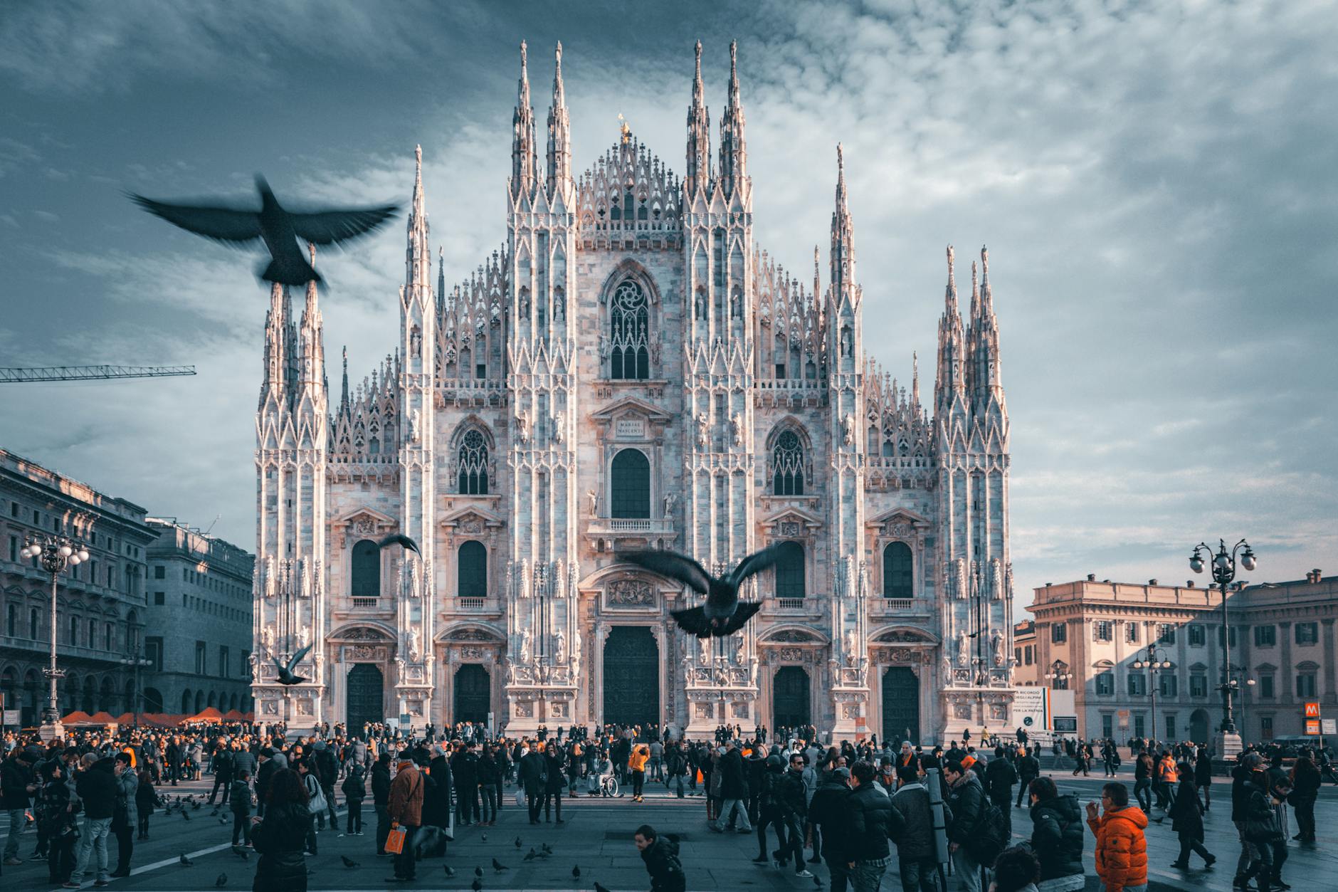 People walking near a white building in Milan