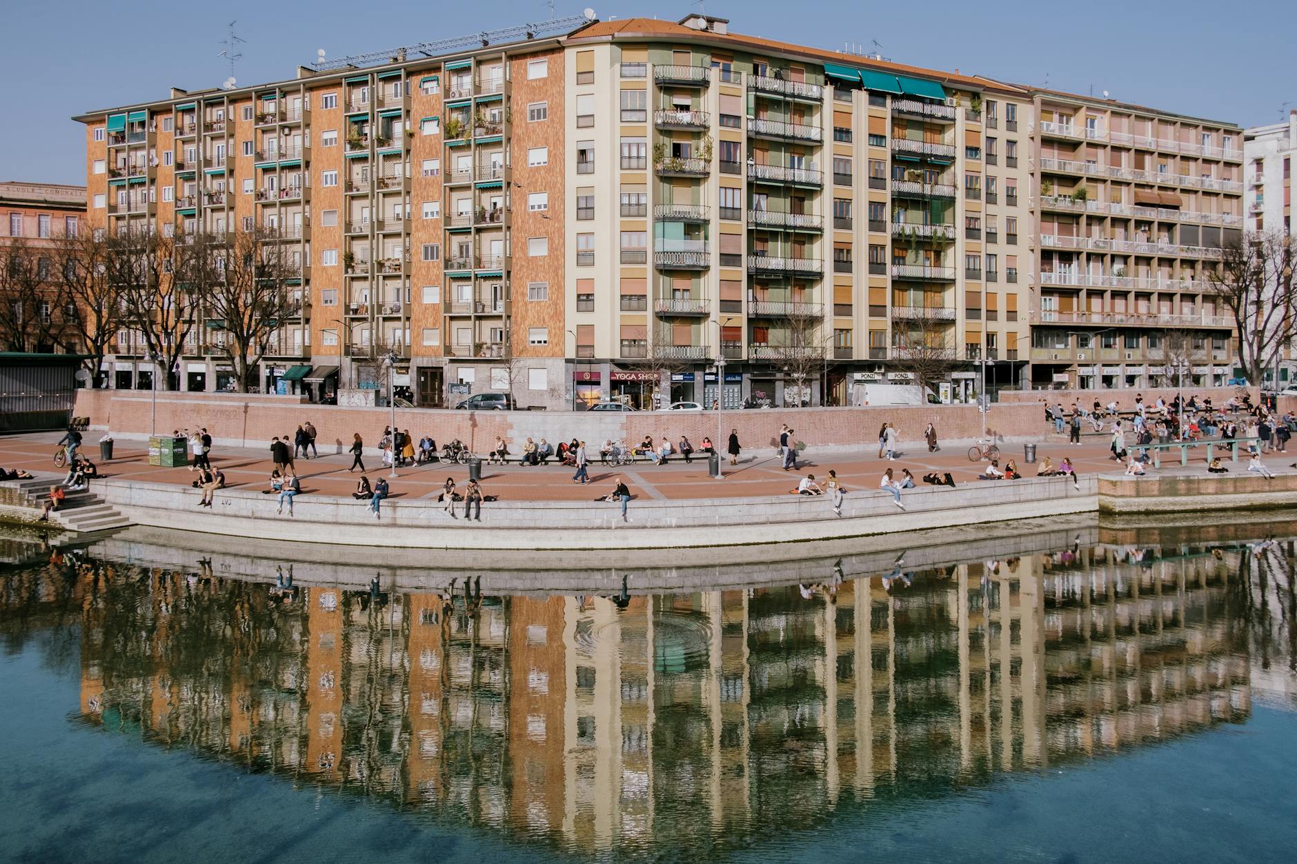 People walking near water in Milan
