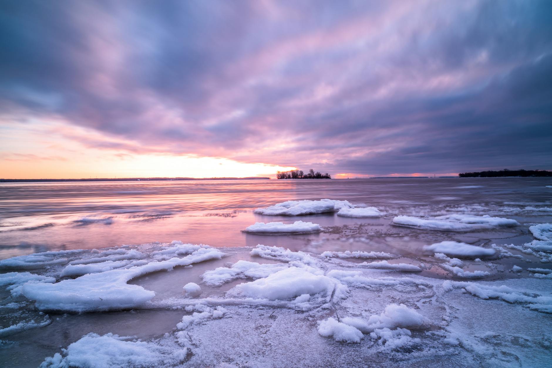 Winter sunset over icy waters in Montreal
