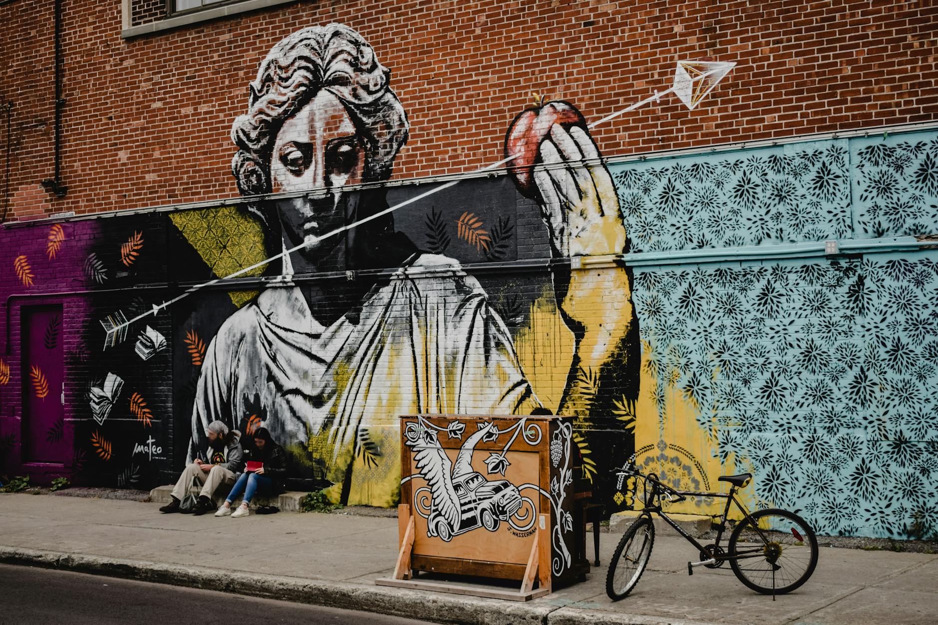 Classical mural on a Montreal brick wall