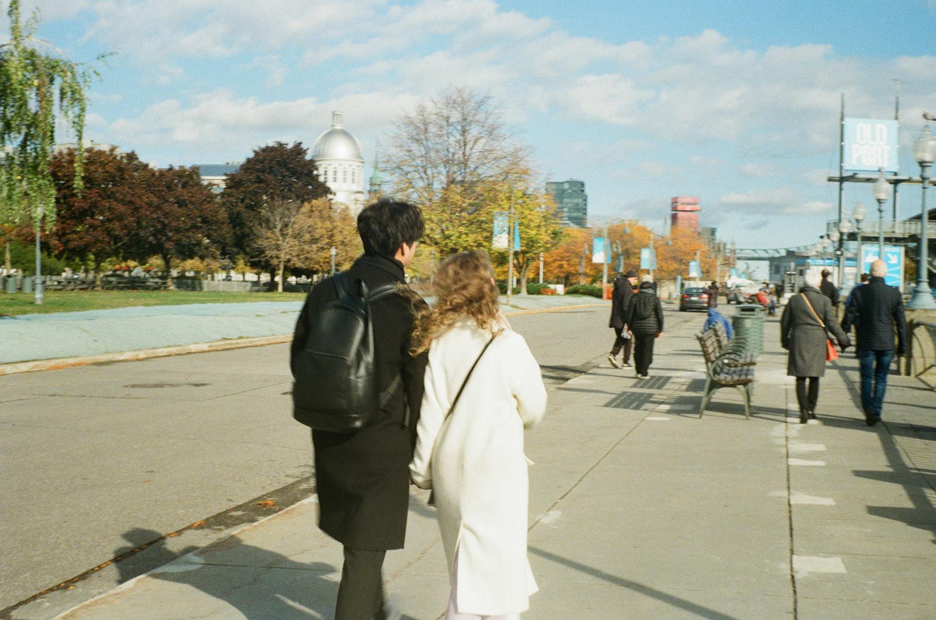 Couple walking through historic Montreal streets