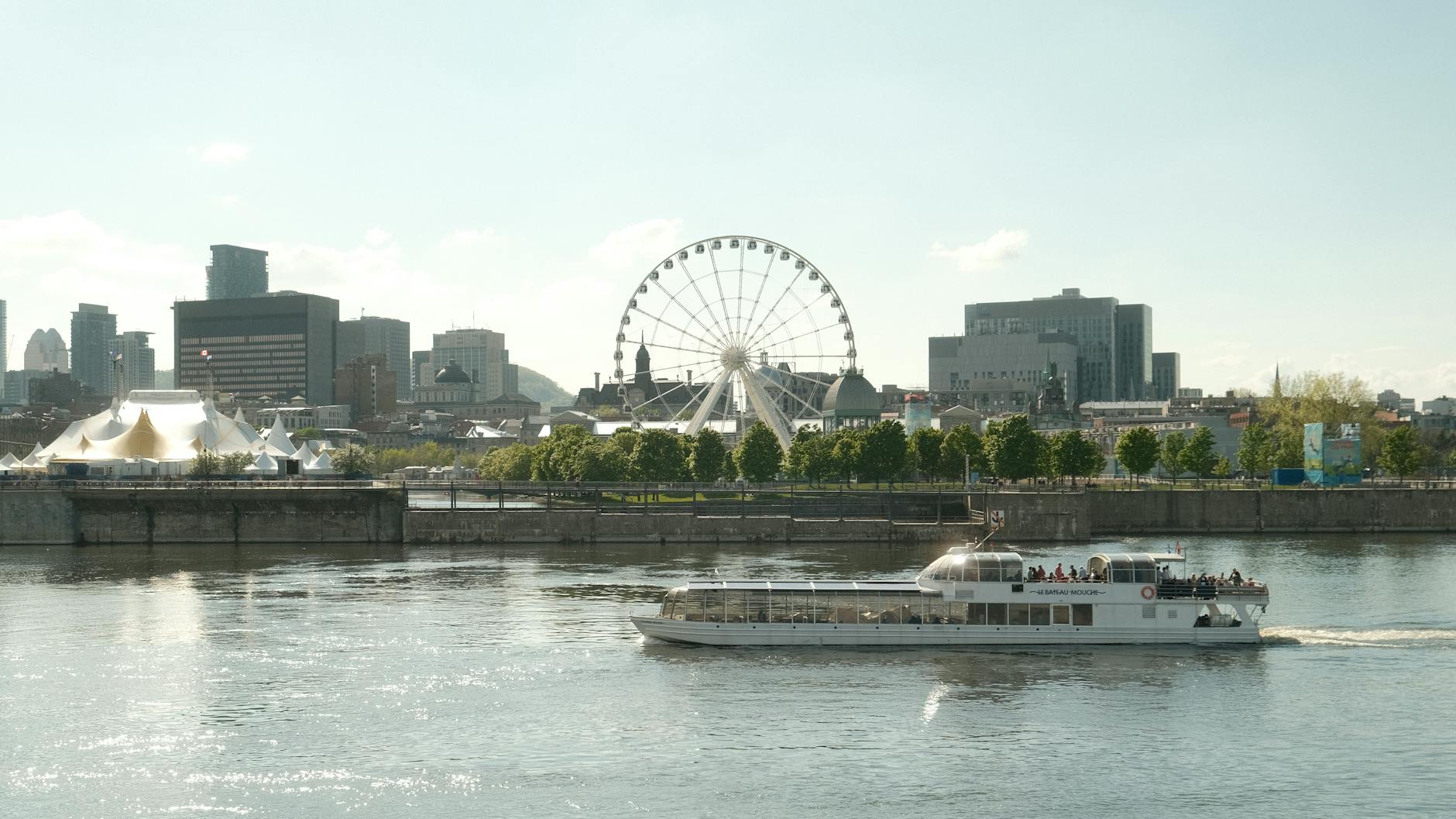 Montreal skyline with river ferry and ferris wheel
