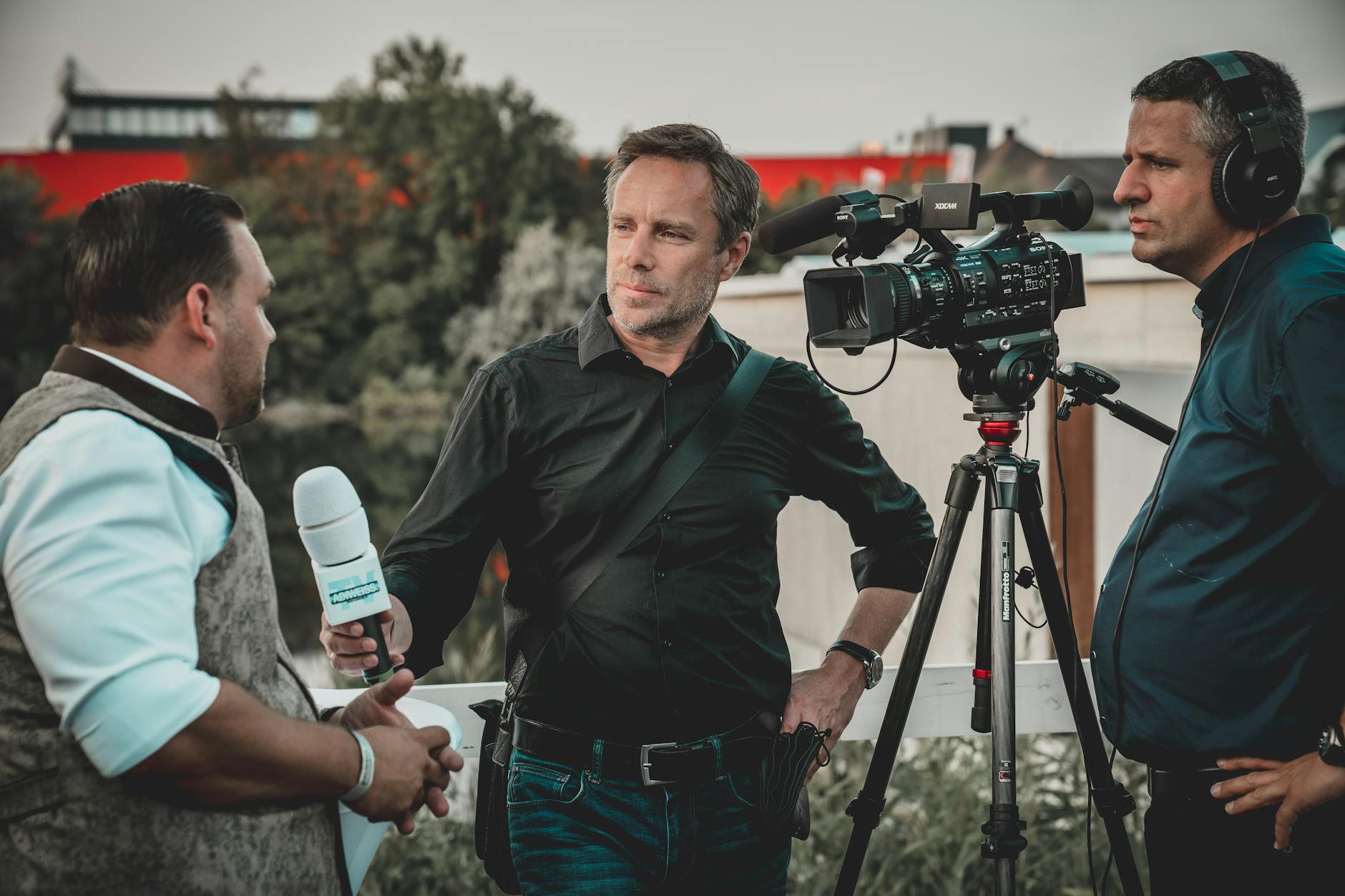 Professional news crew filming an outdoor interview