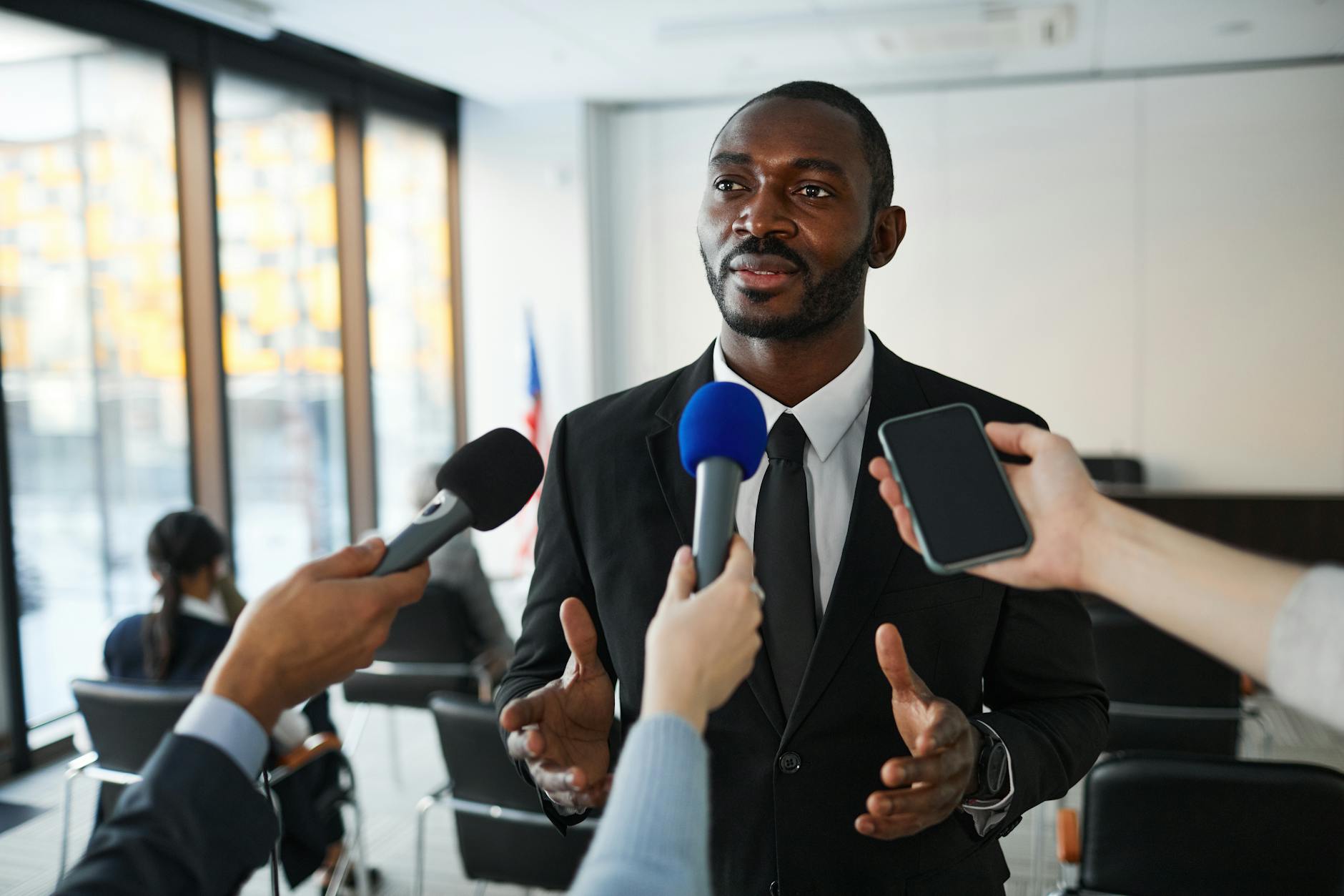 Person answering media questions at a press conference