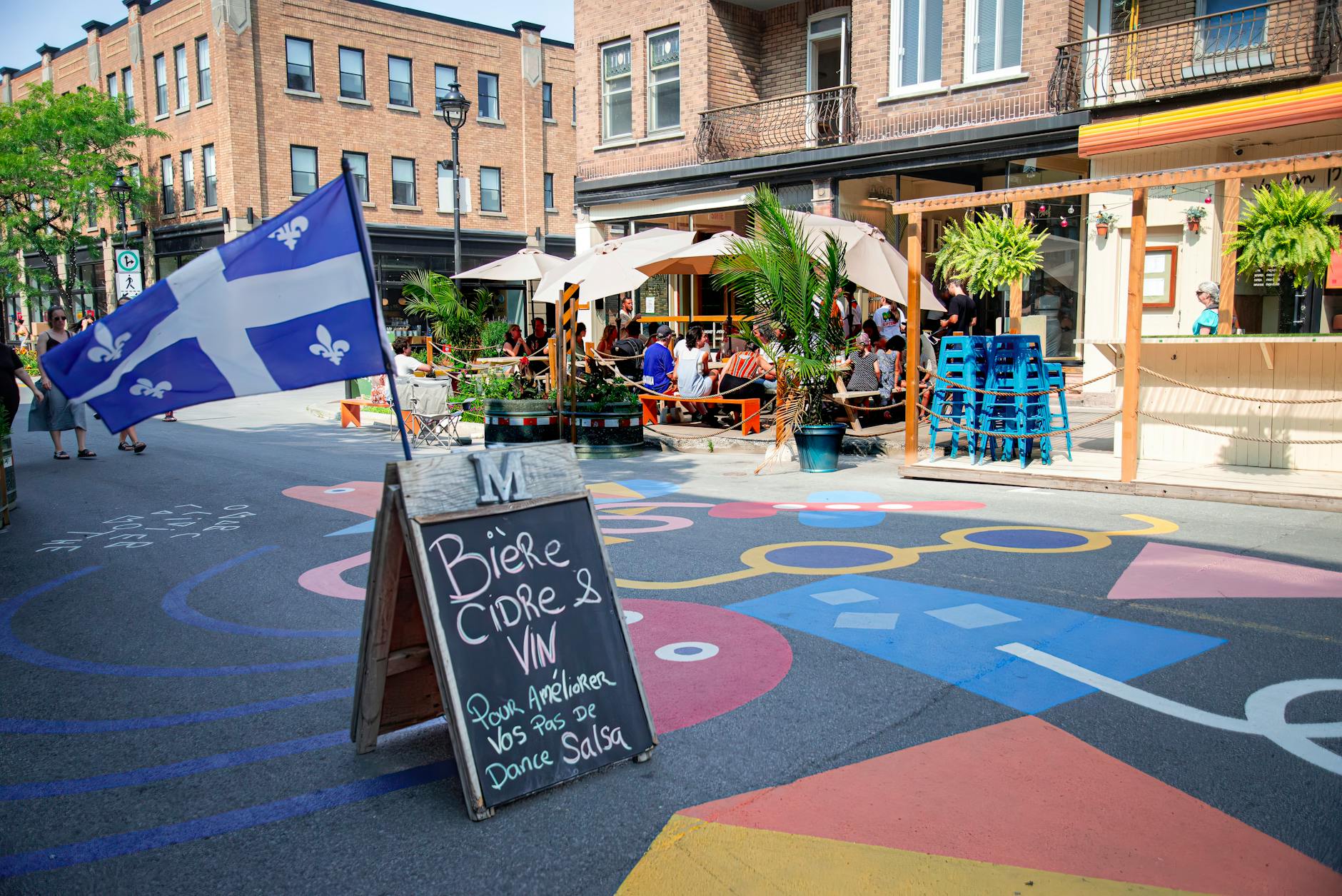 Montreal street with Quebec flag and outdoor cafe
