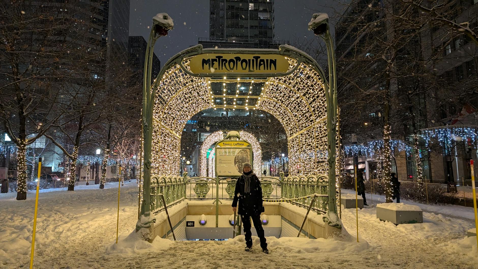 Snowy Montreal metro entrance at night