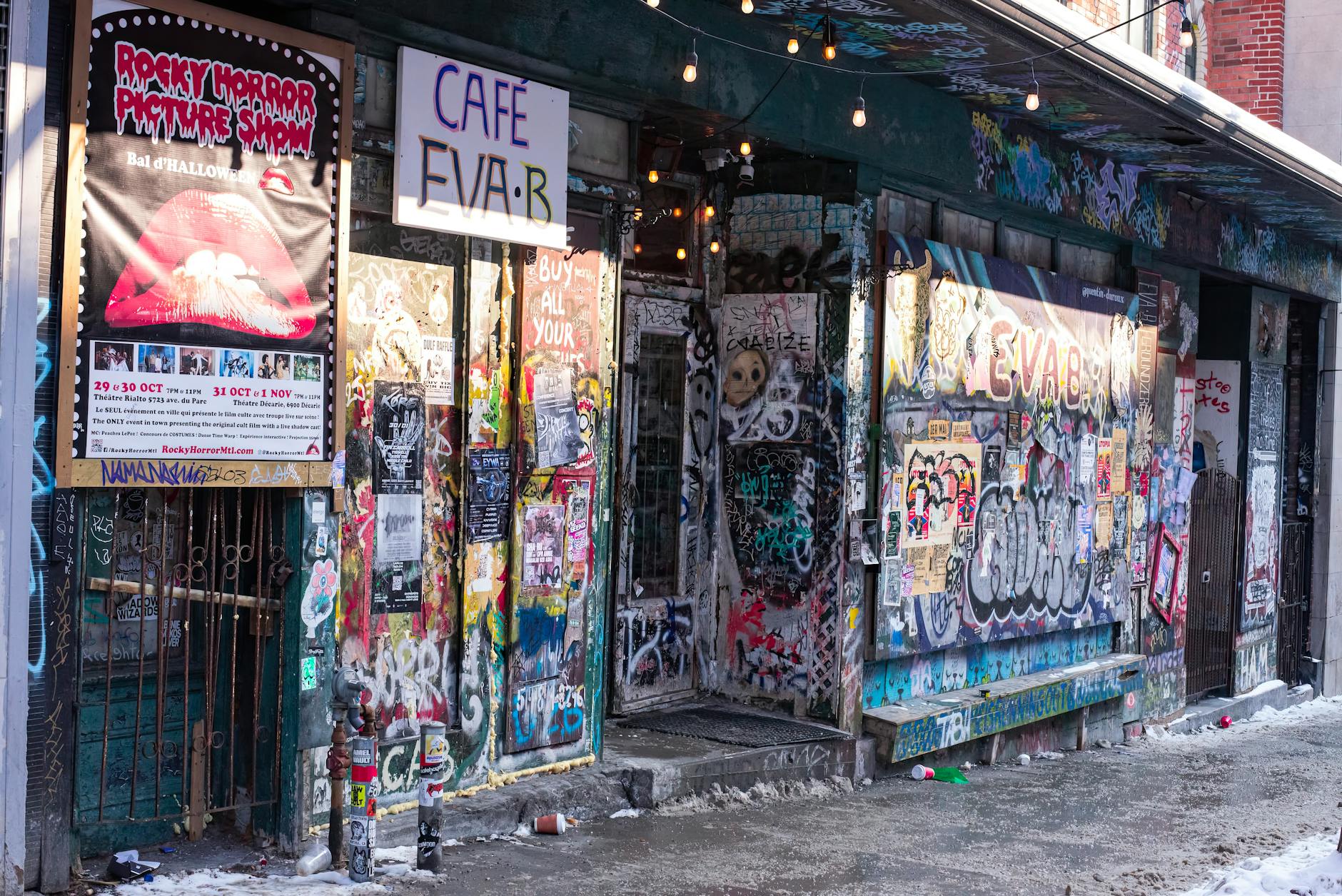 Graffiti-covered Montreal alley with cafe signs