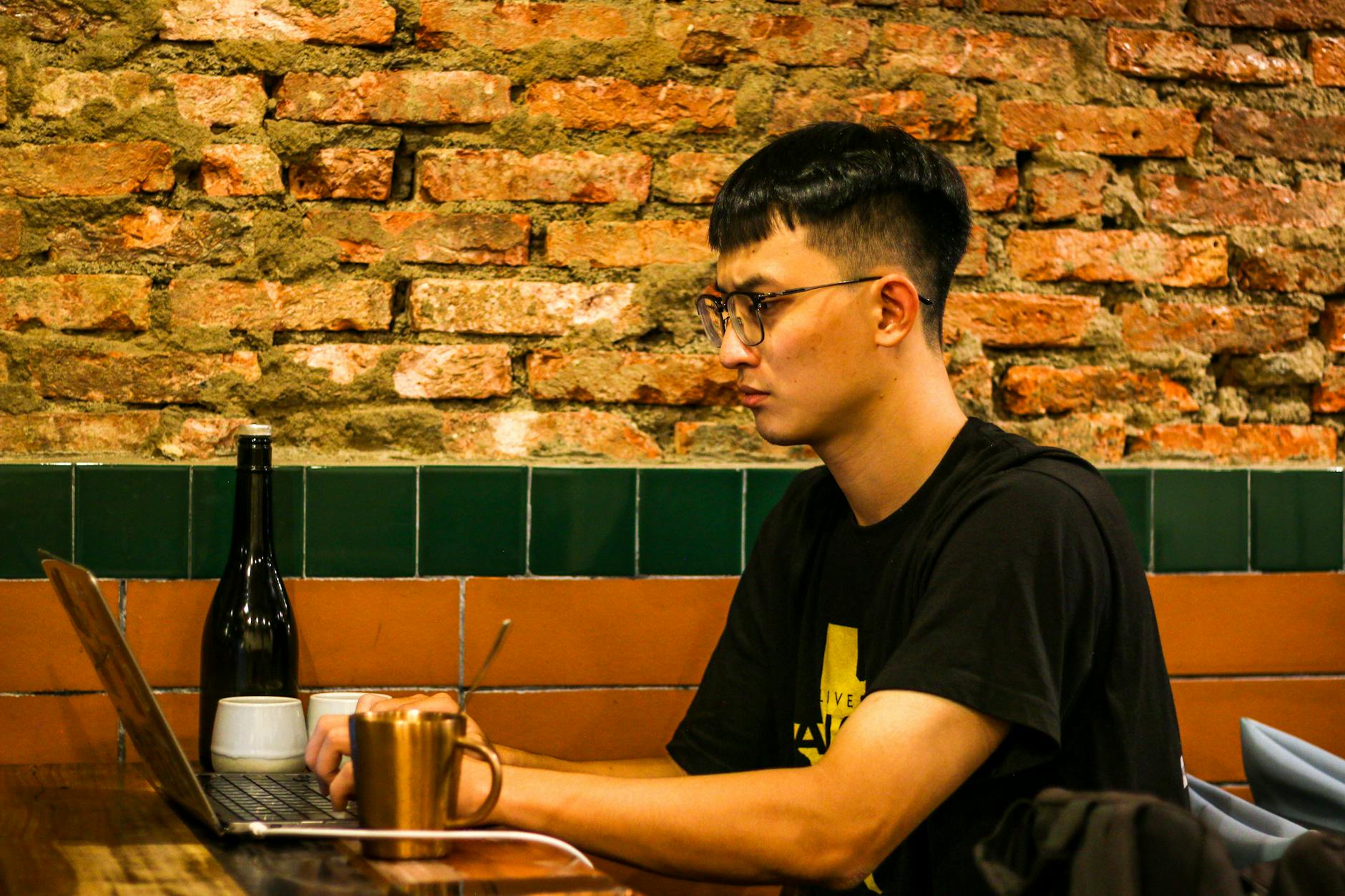 Student working on a laptop in a cafe