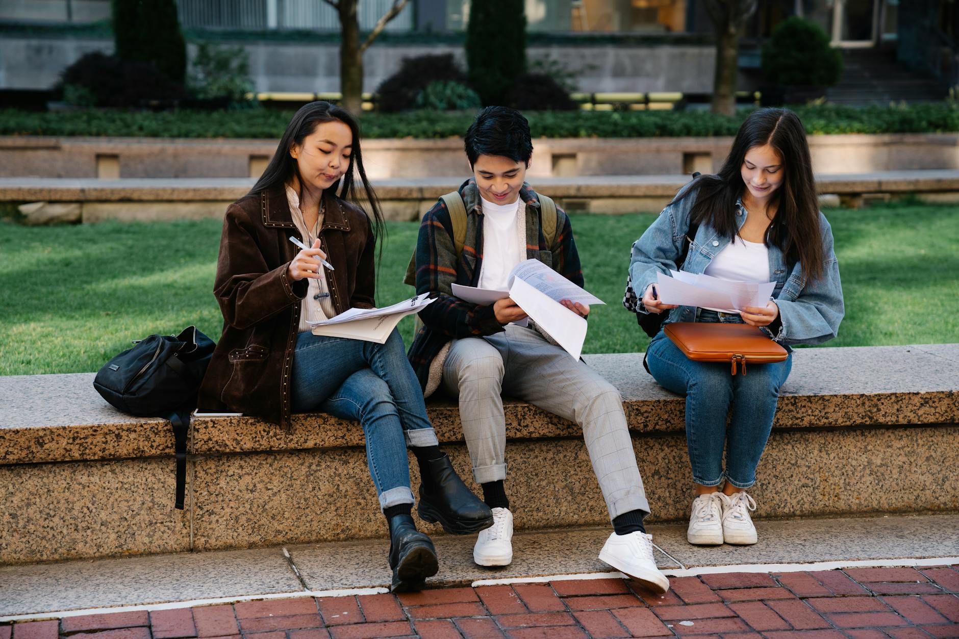 Students studying together on a campus bench