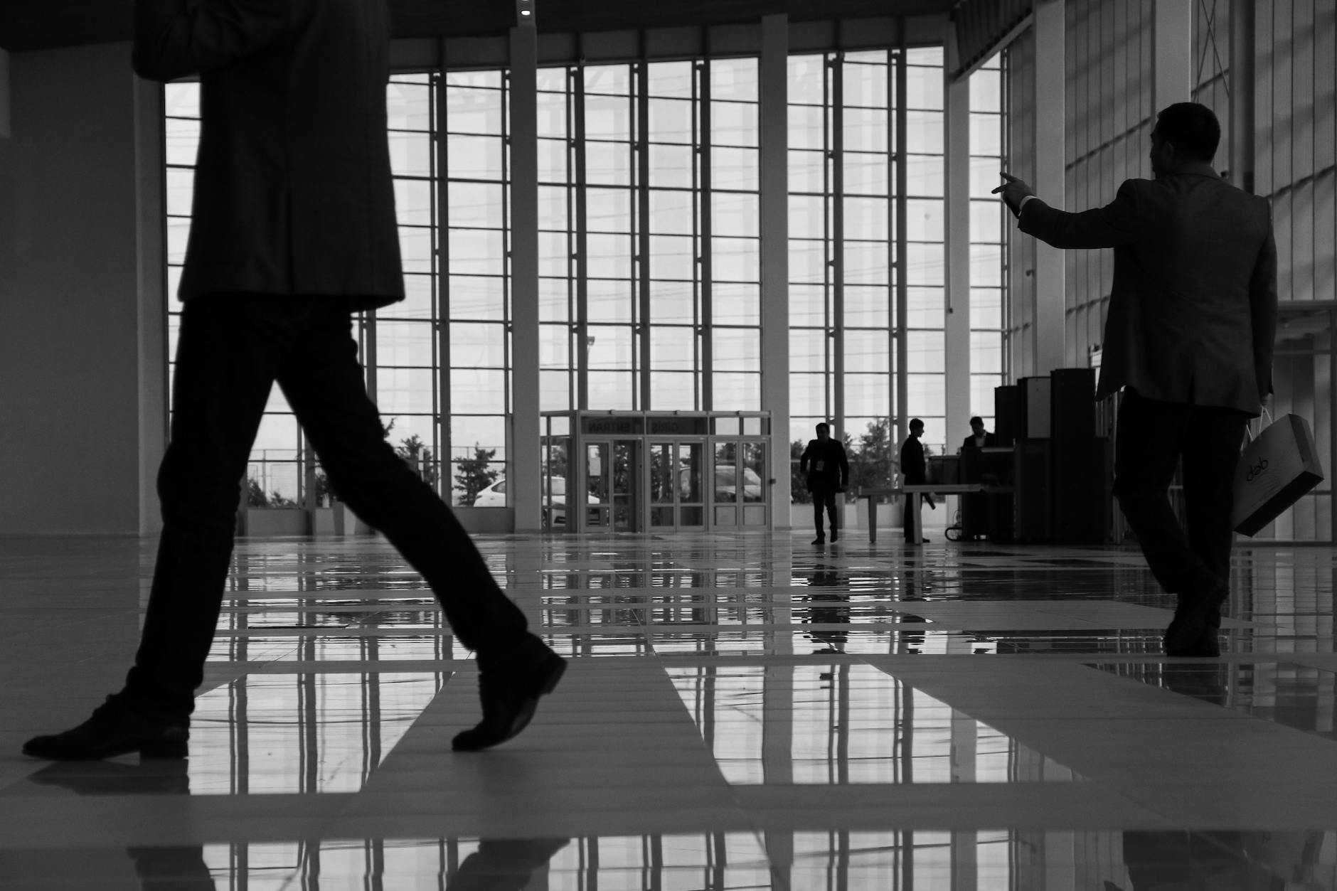 Business professionals walking through a glass interior