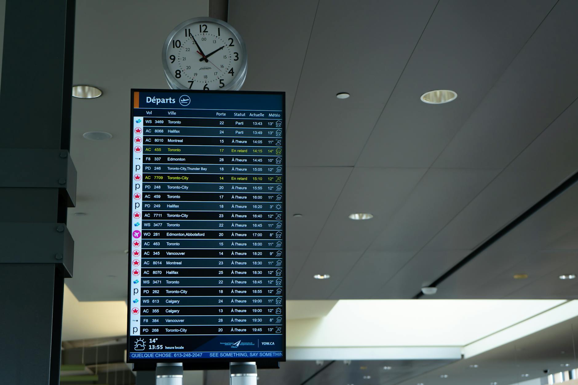 Airport departure board with flight schedules