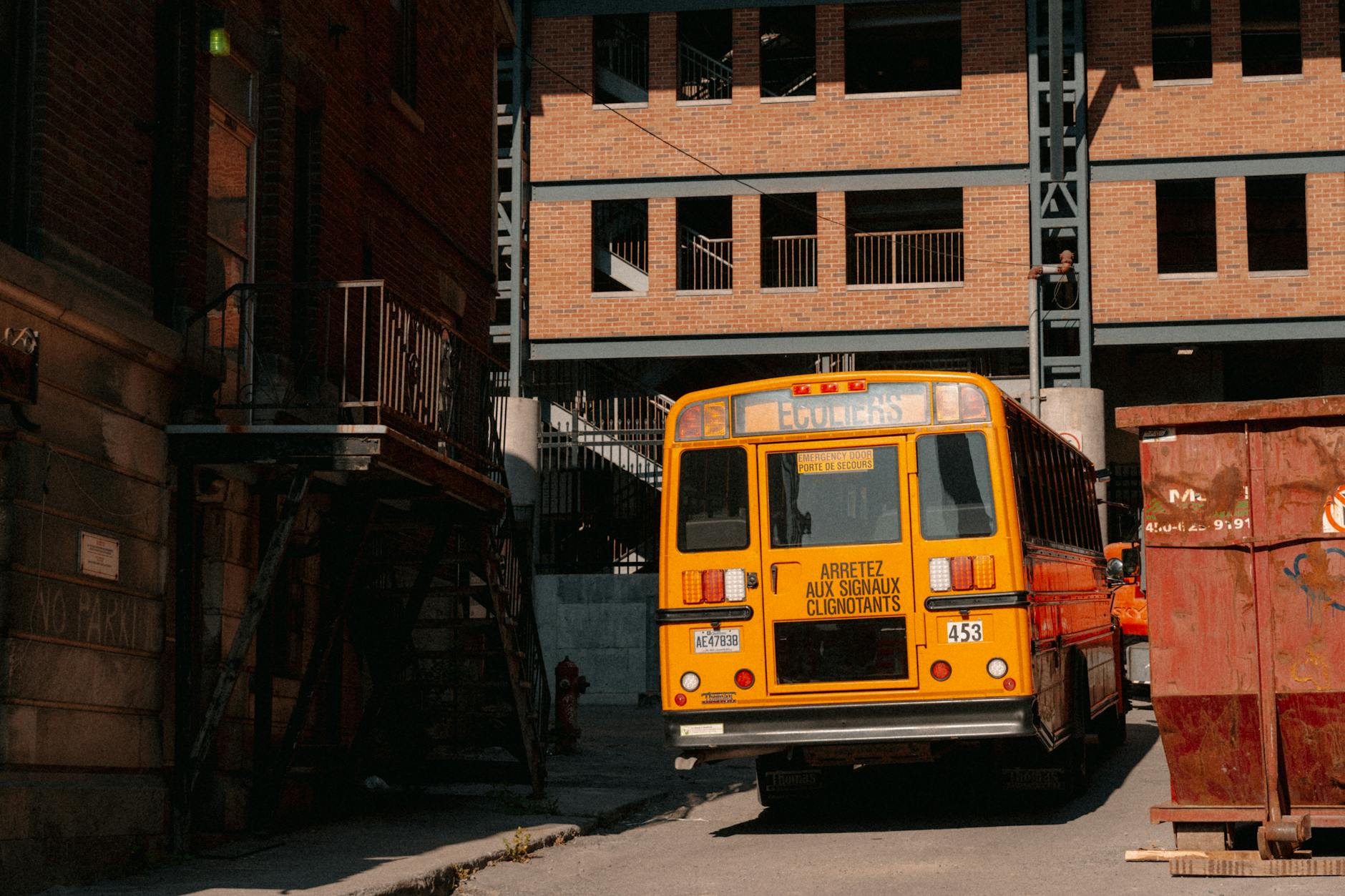 Yellow bus in a Montreal alleyway