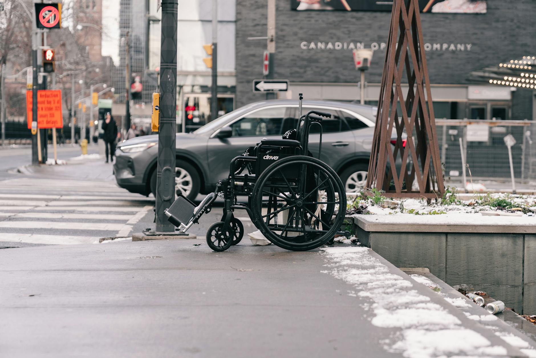 Wheelchair on snowy city sidewalk