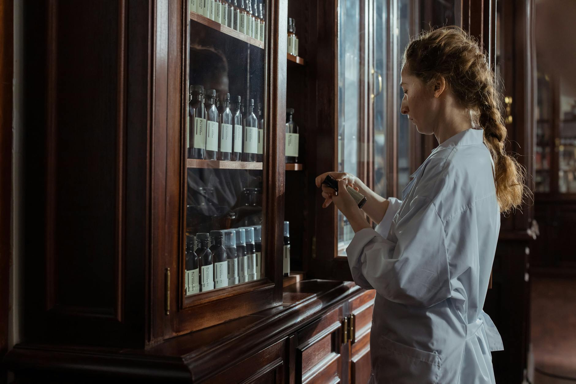 Pharmacist arranging medicine bottles
