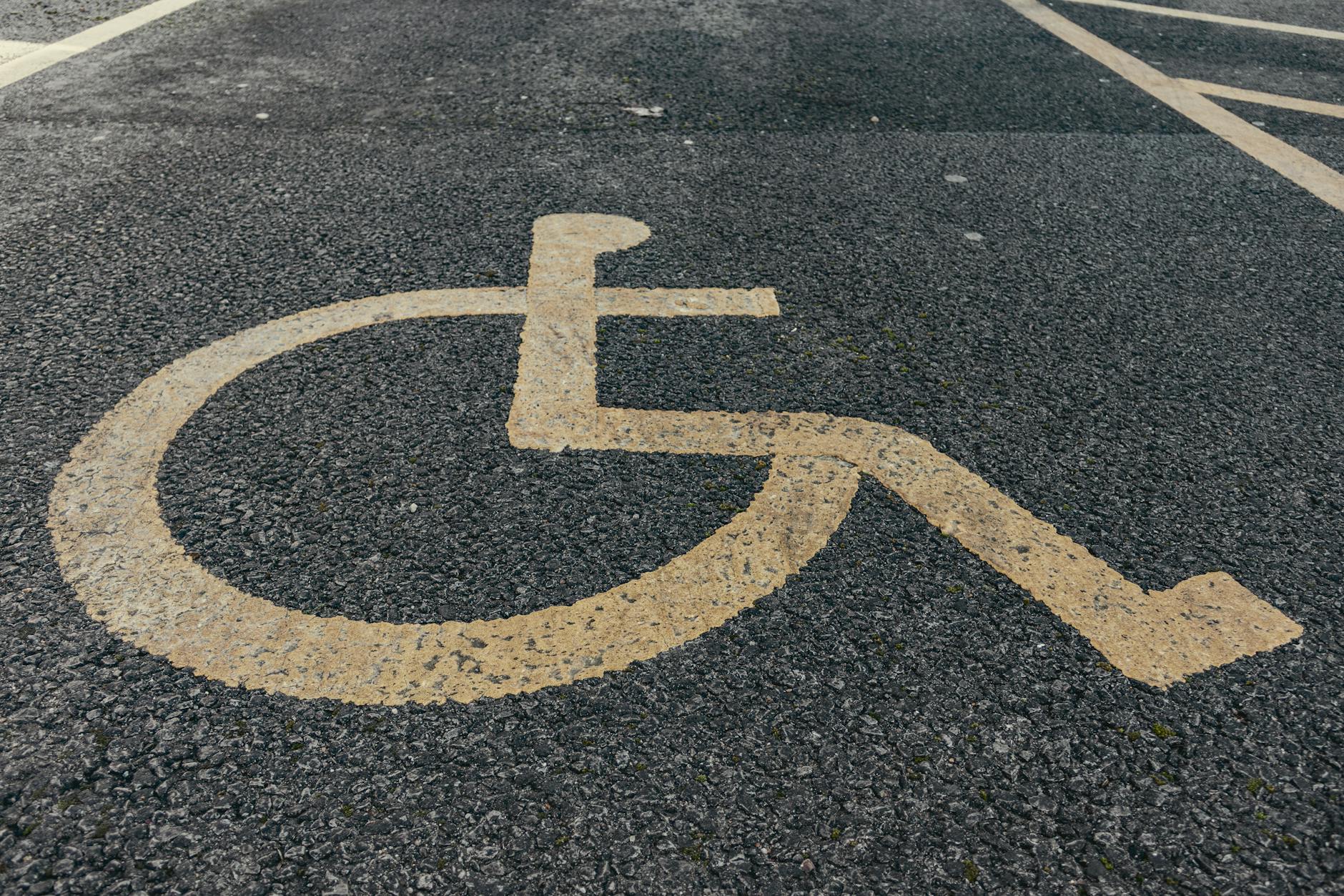 Painted accessible parking symbol on pavement