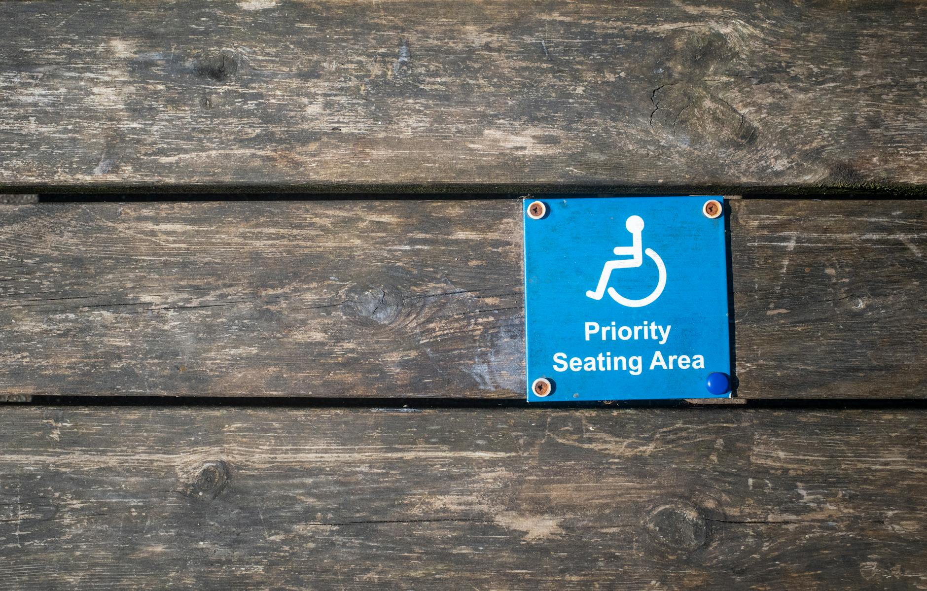 Priority seating sign with wheelchair symbol