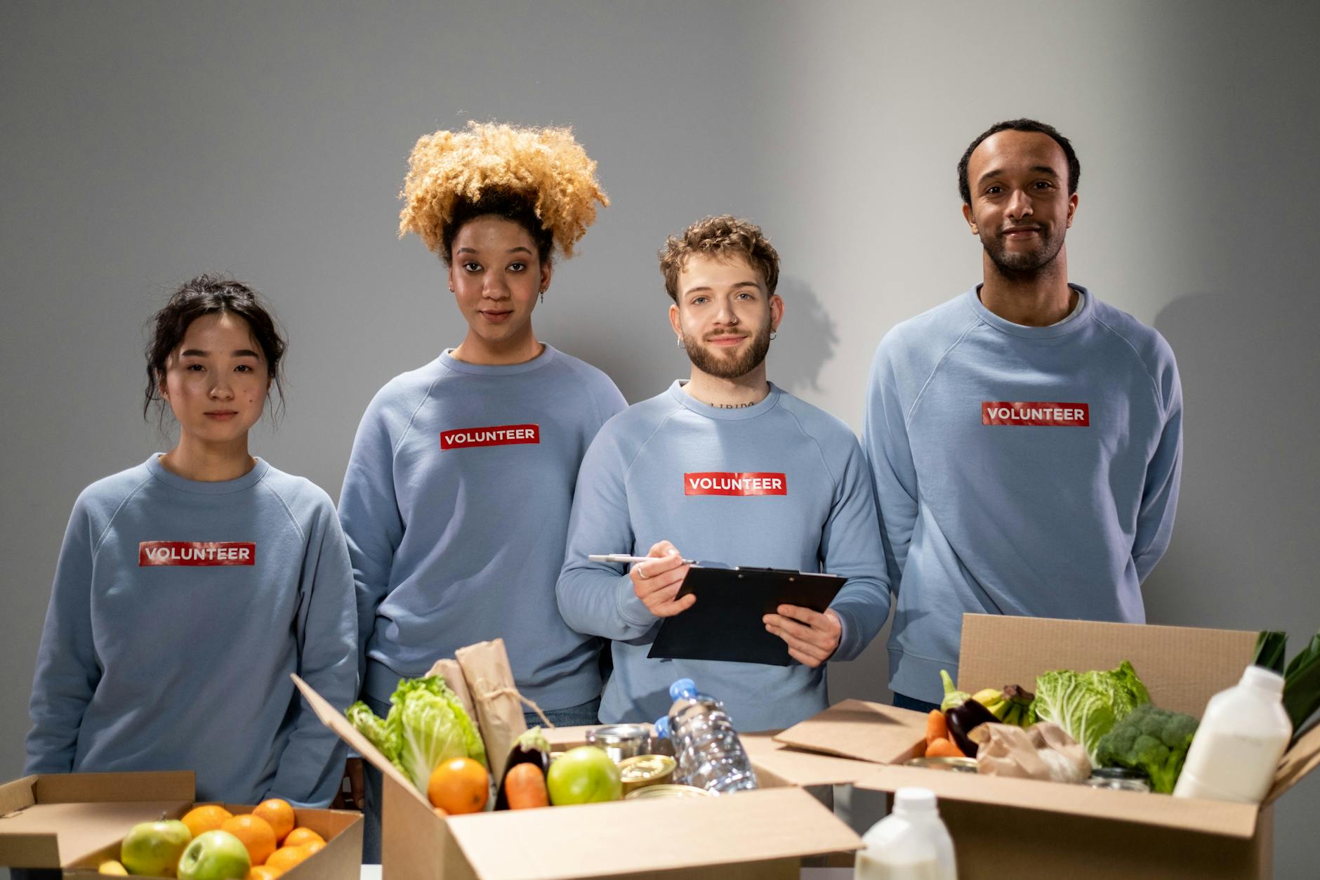 Volunteers organizing food donations with clipboards