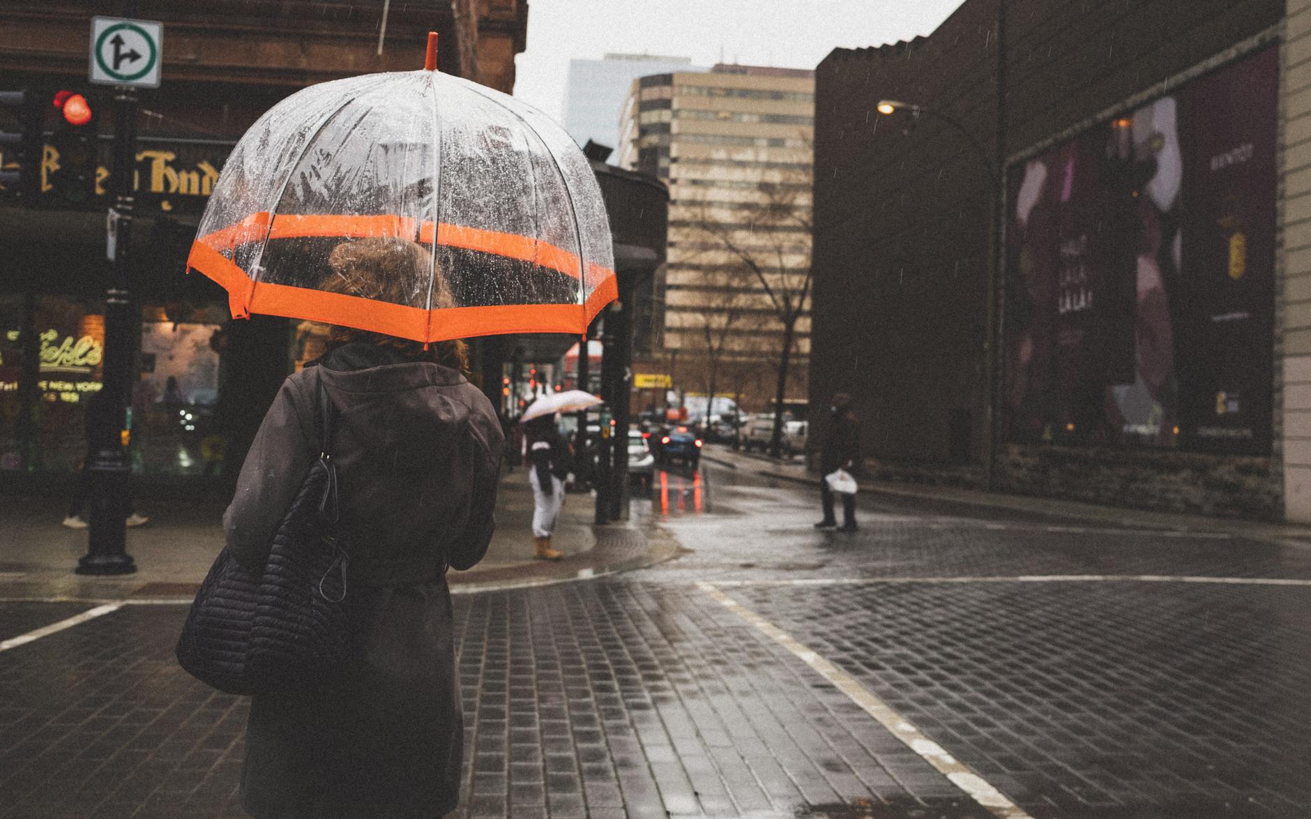 Rainy Montreal city street with umbrellas