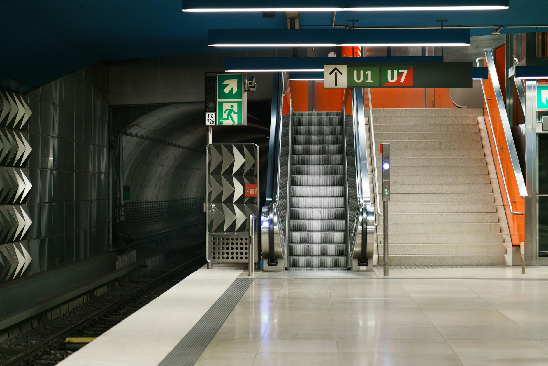 Munich subway station with escalators and signage