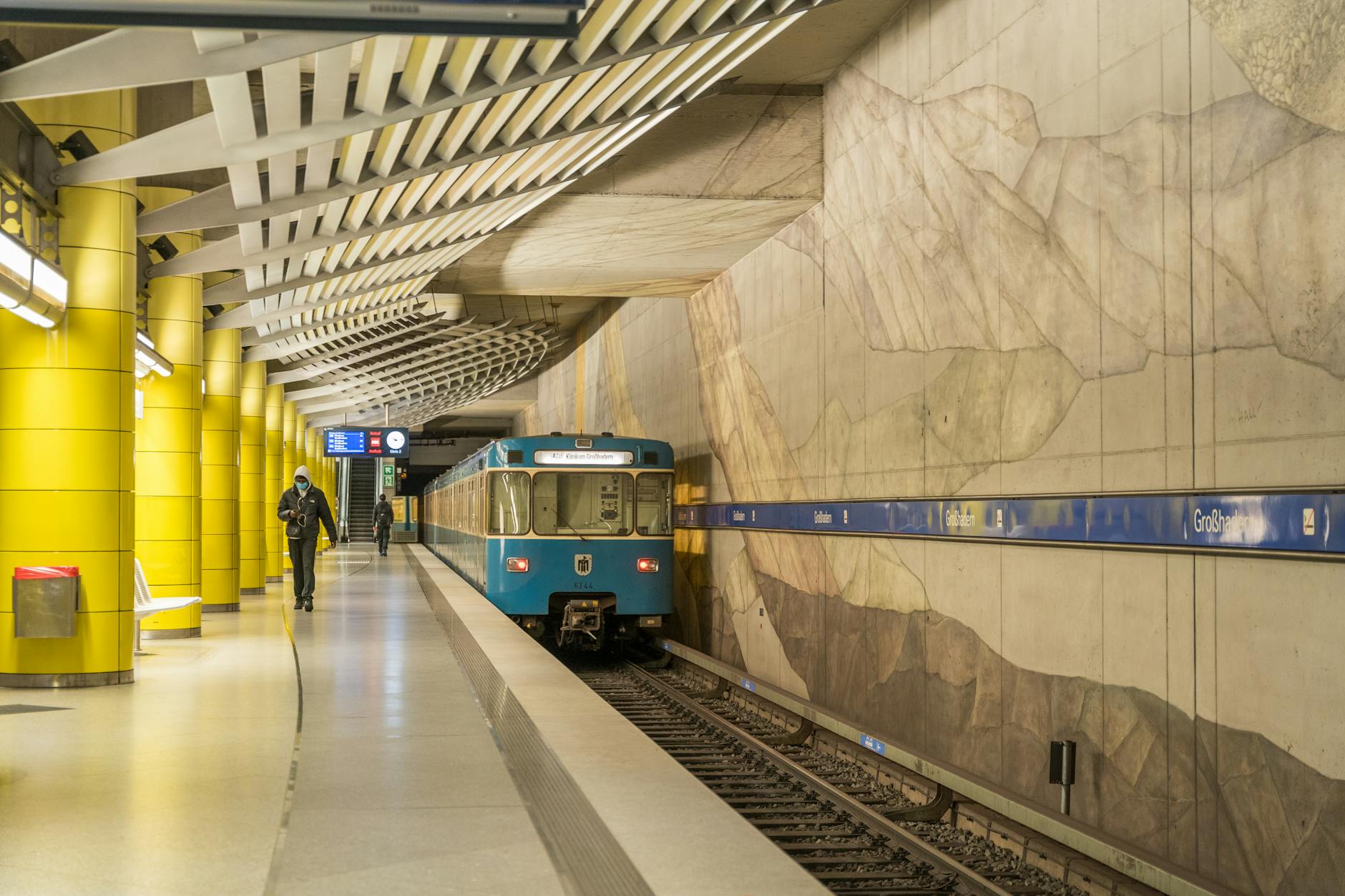 Modern Munich subway station with train approaching
