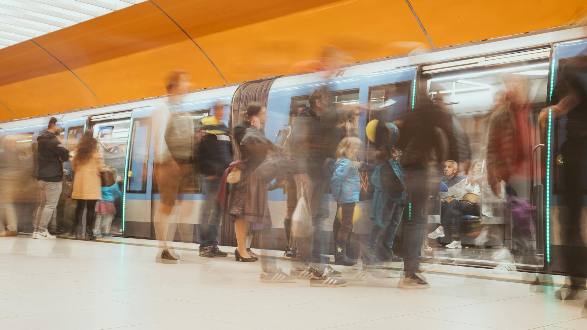 Passengers moving through a Munich subway platform