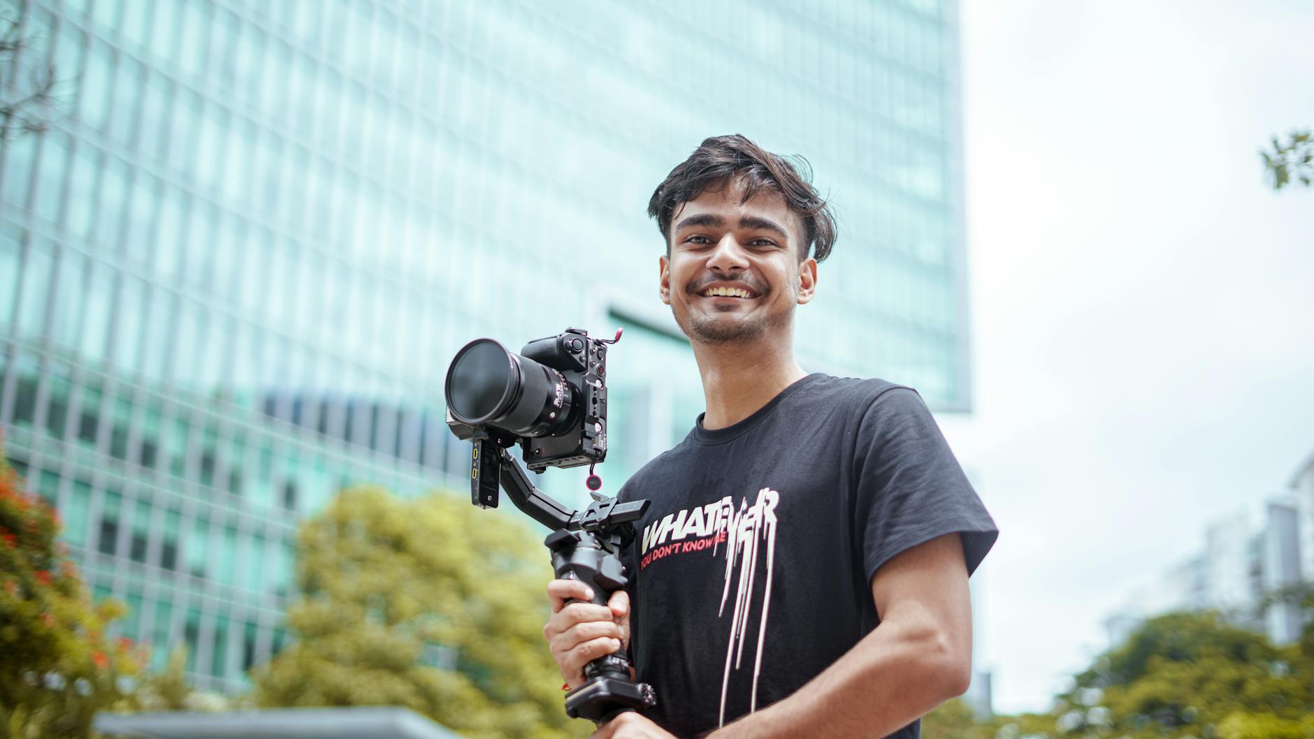 Filmmaker holding a camera outdoors