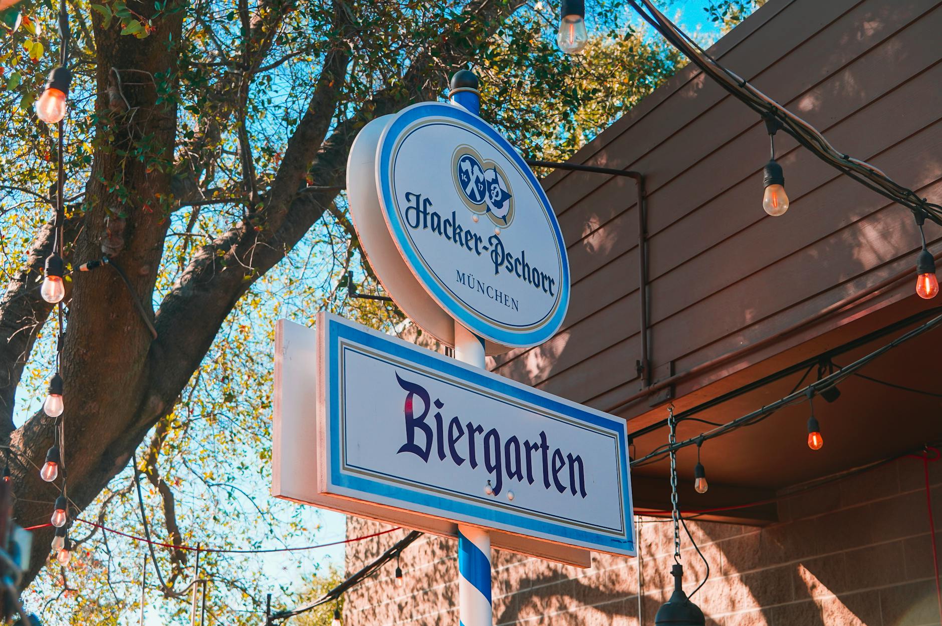 Beer garden sign under trees in Munich