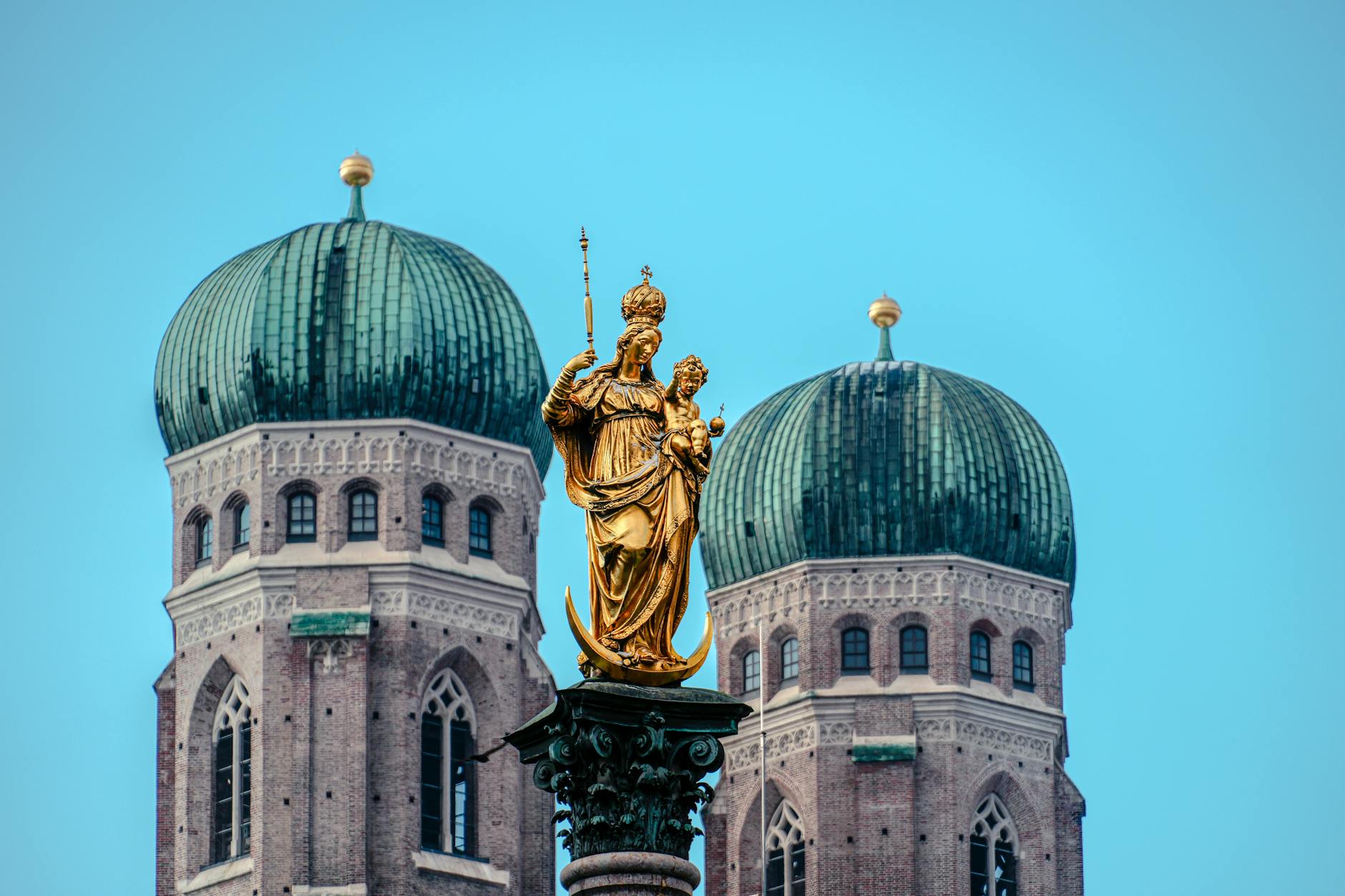 Marienplatz statue and Frauenkirche towers in Munich