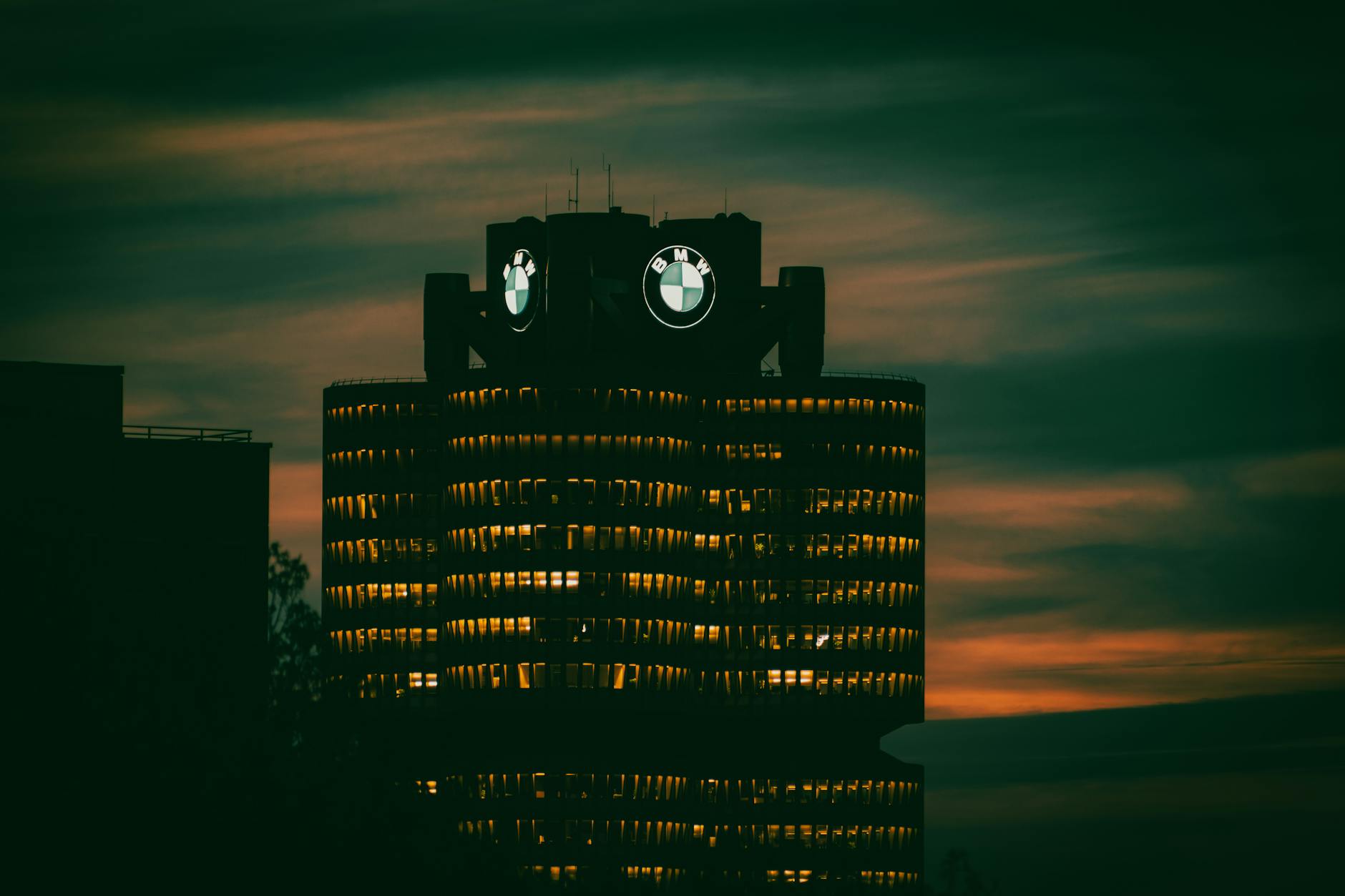 BMW headquarters illuminated at night in Munich