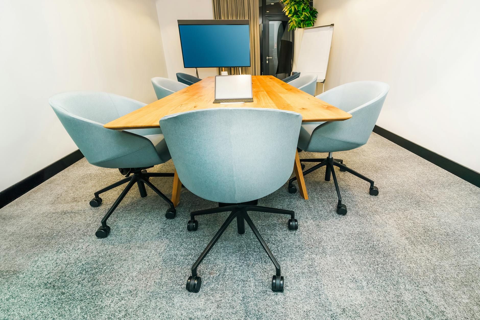 Conference room with table, chairs, and screen