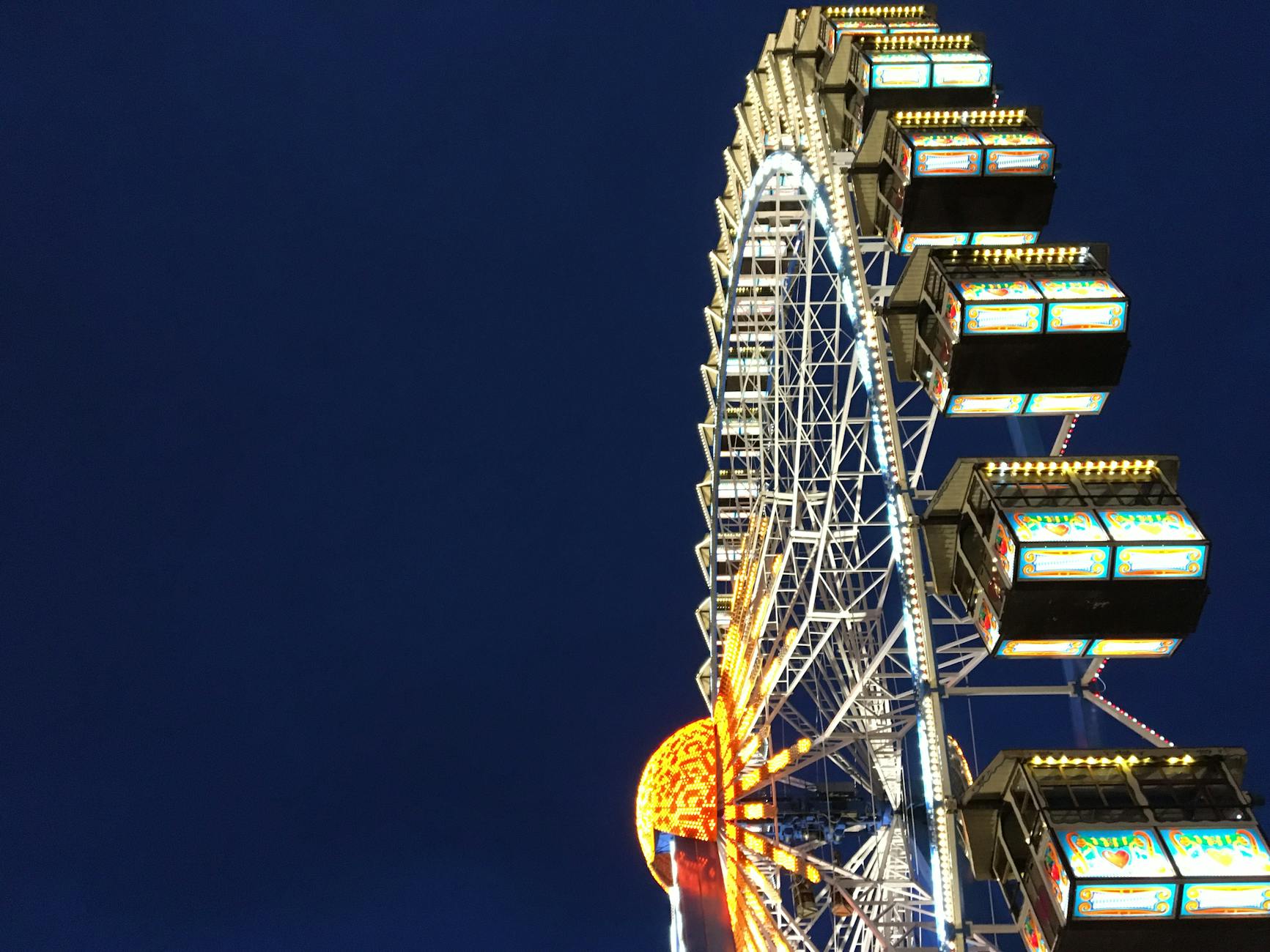 Ferris wheel lit at night in Munich