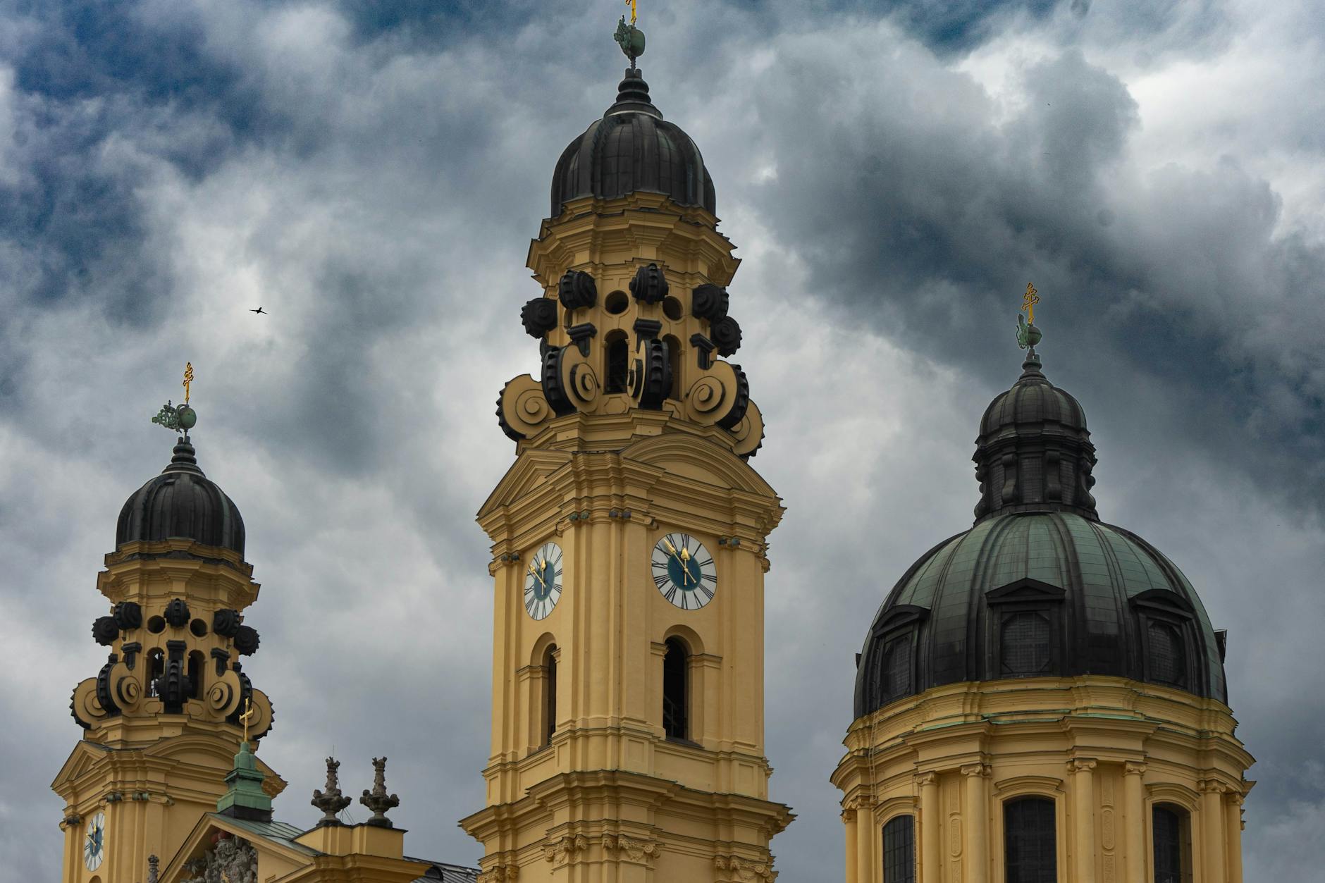 Theatine Church towers under a cloudy sky in Munich