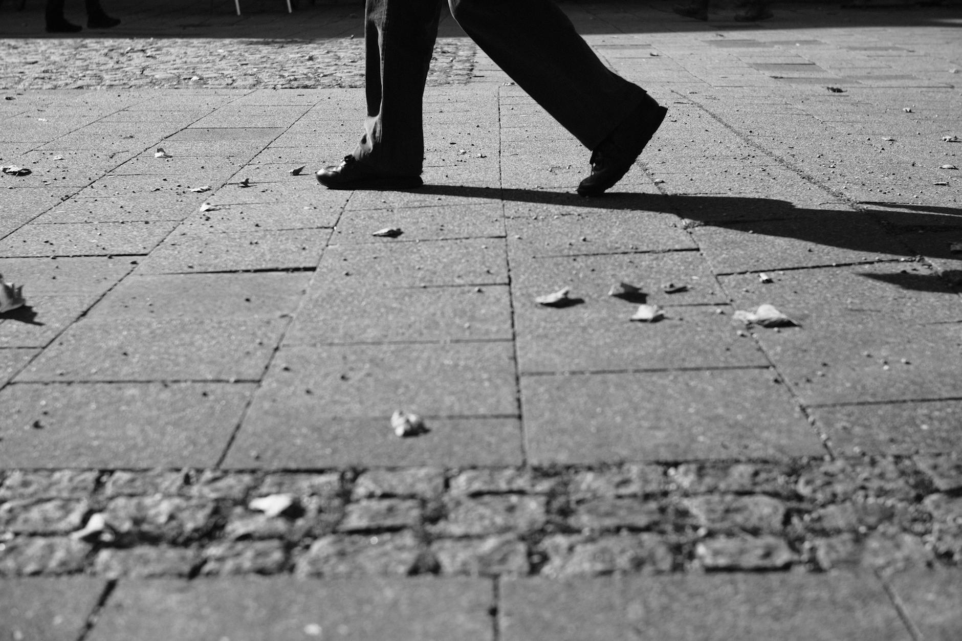 Person walking on cobblestone pavement in Munich