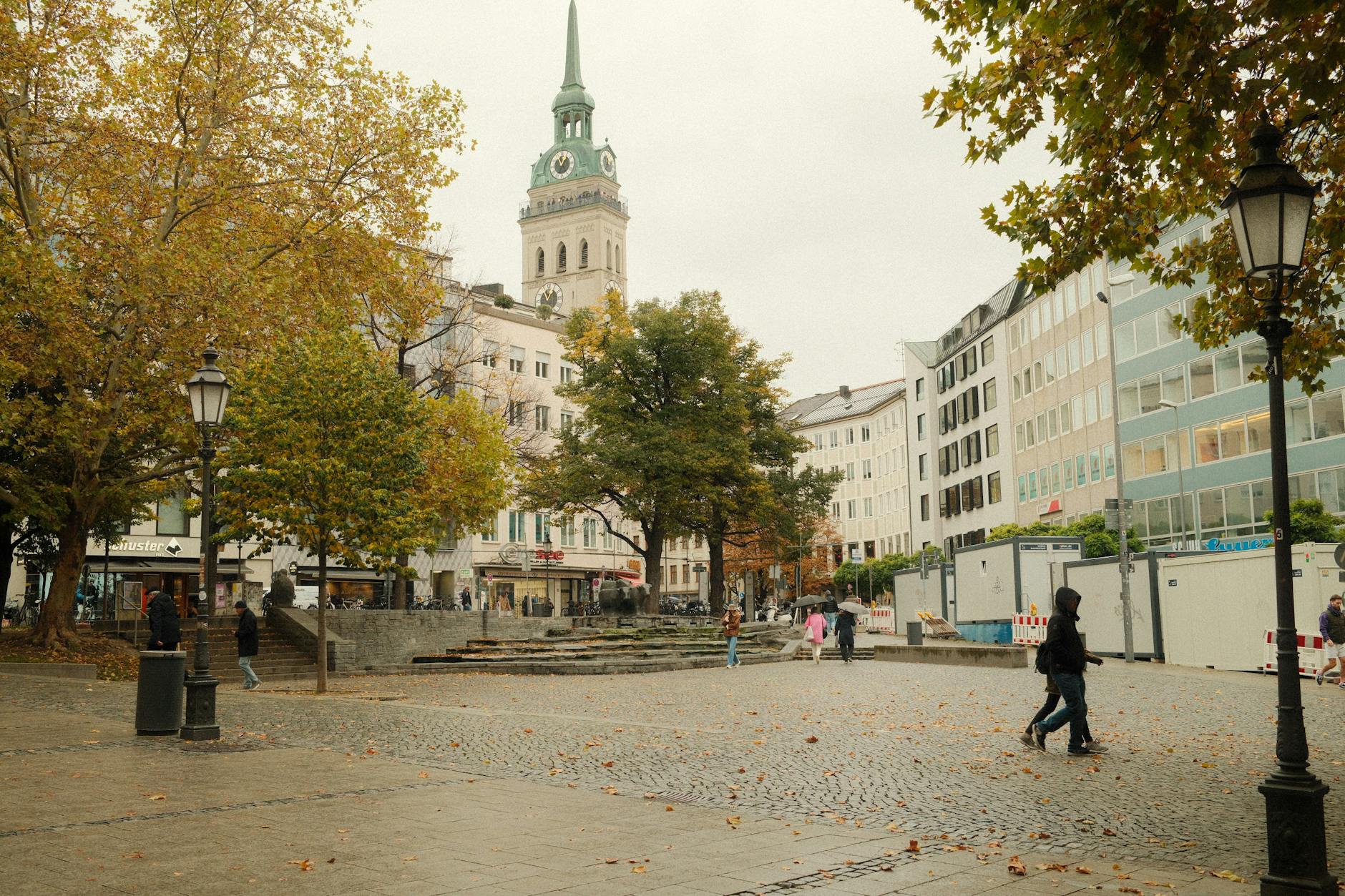 People walking past historic buildings in Munich