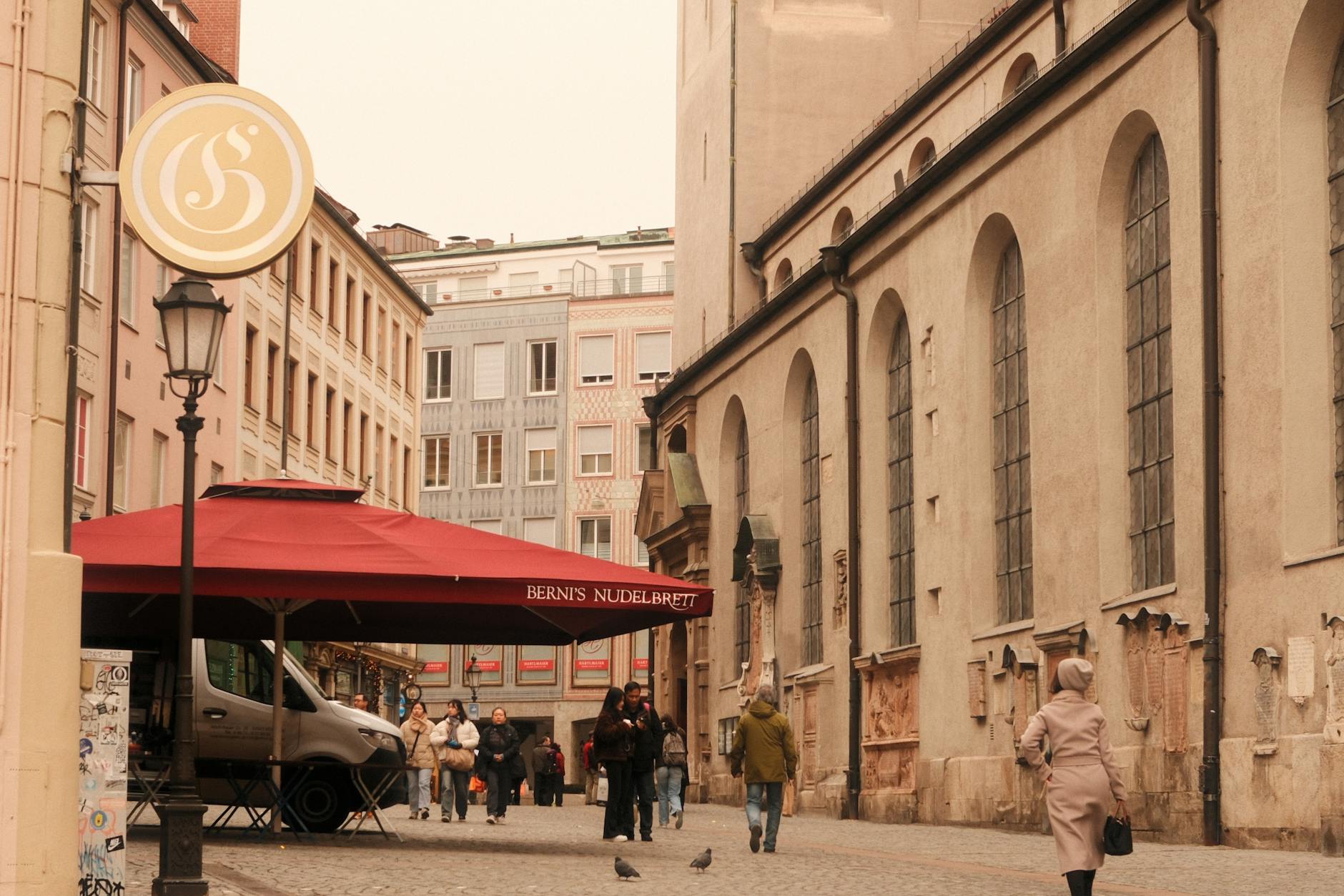 Munich street with historic architecture and outdoor cafe