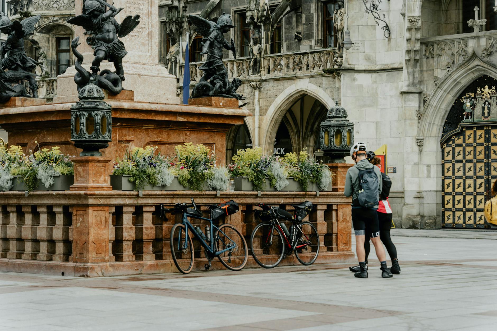Cyclists near a fountain in Munich's Marienplatz
