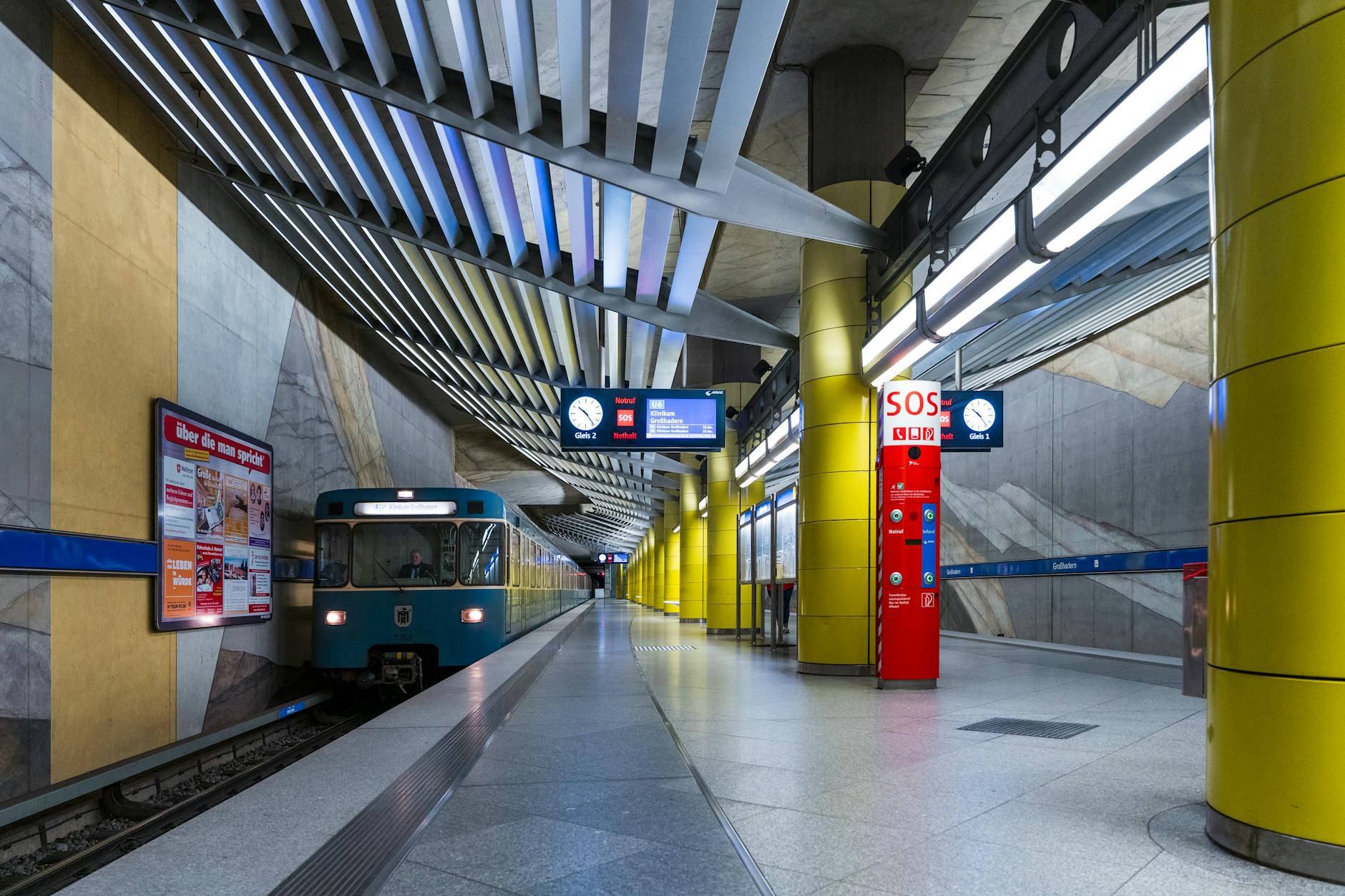 Munich subway platform with a blue train