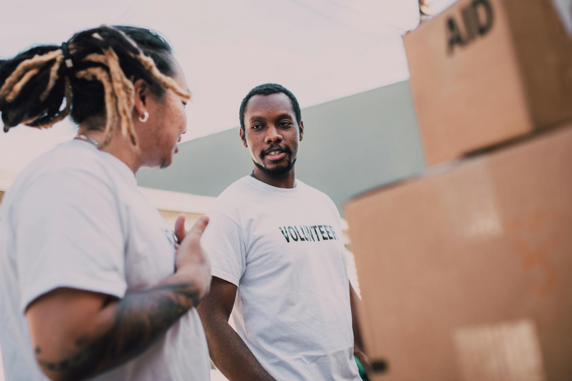 Volunteers organizing aid packages outdoors