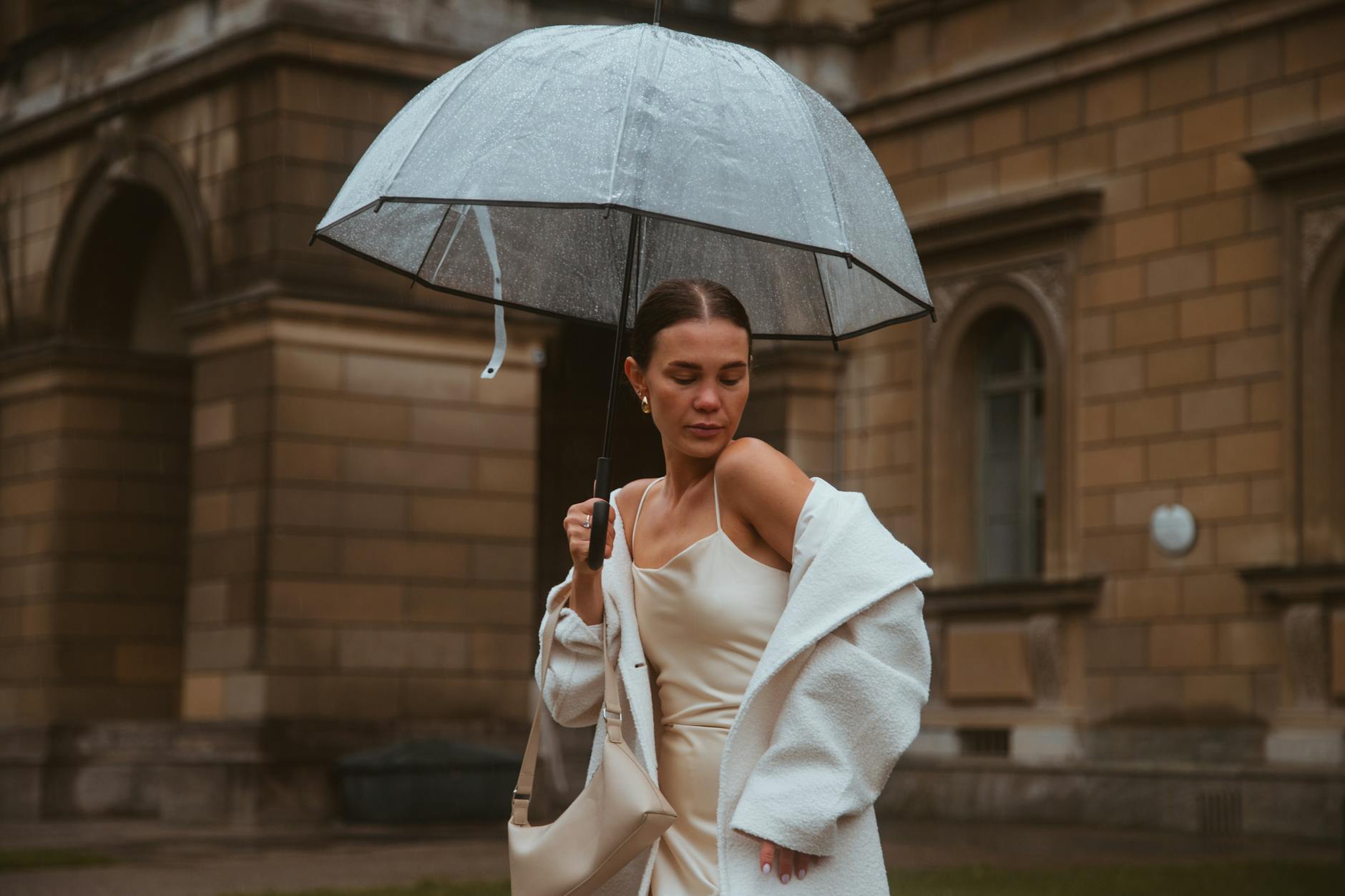 Woman with umbrella on a rainy Munich street