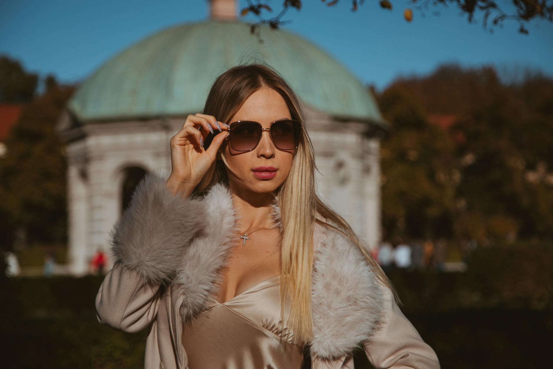 Woman in sunglasses in a Munich garden setting