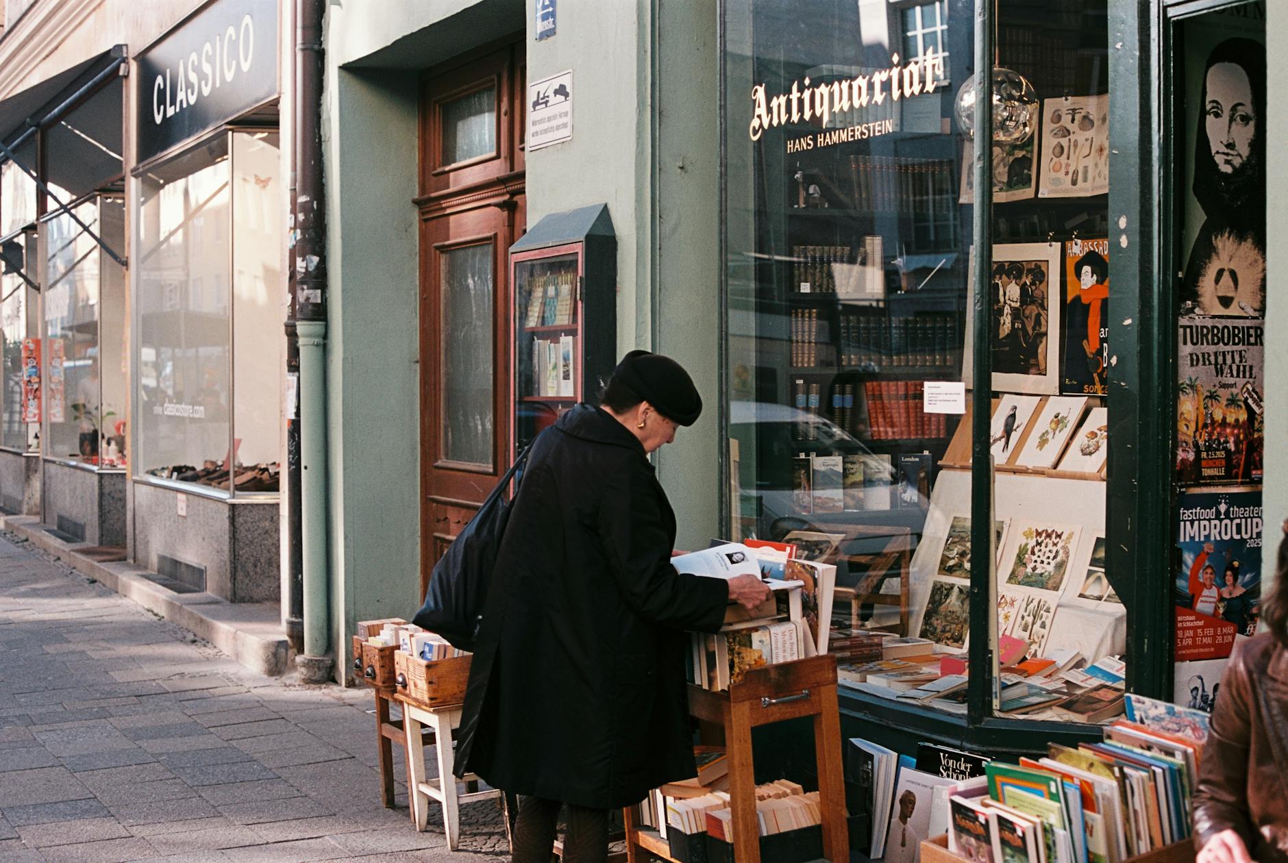 Person browsing books outside a Munich bookstore