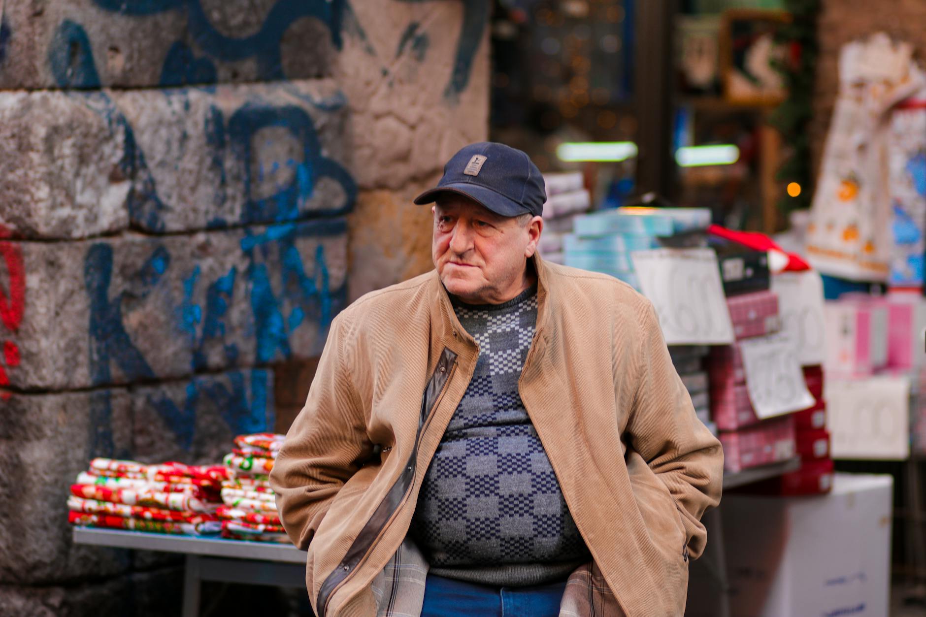 Vendor in a Naples market surrounded by colorful goods