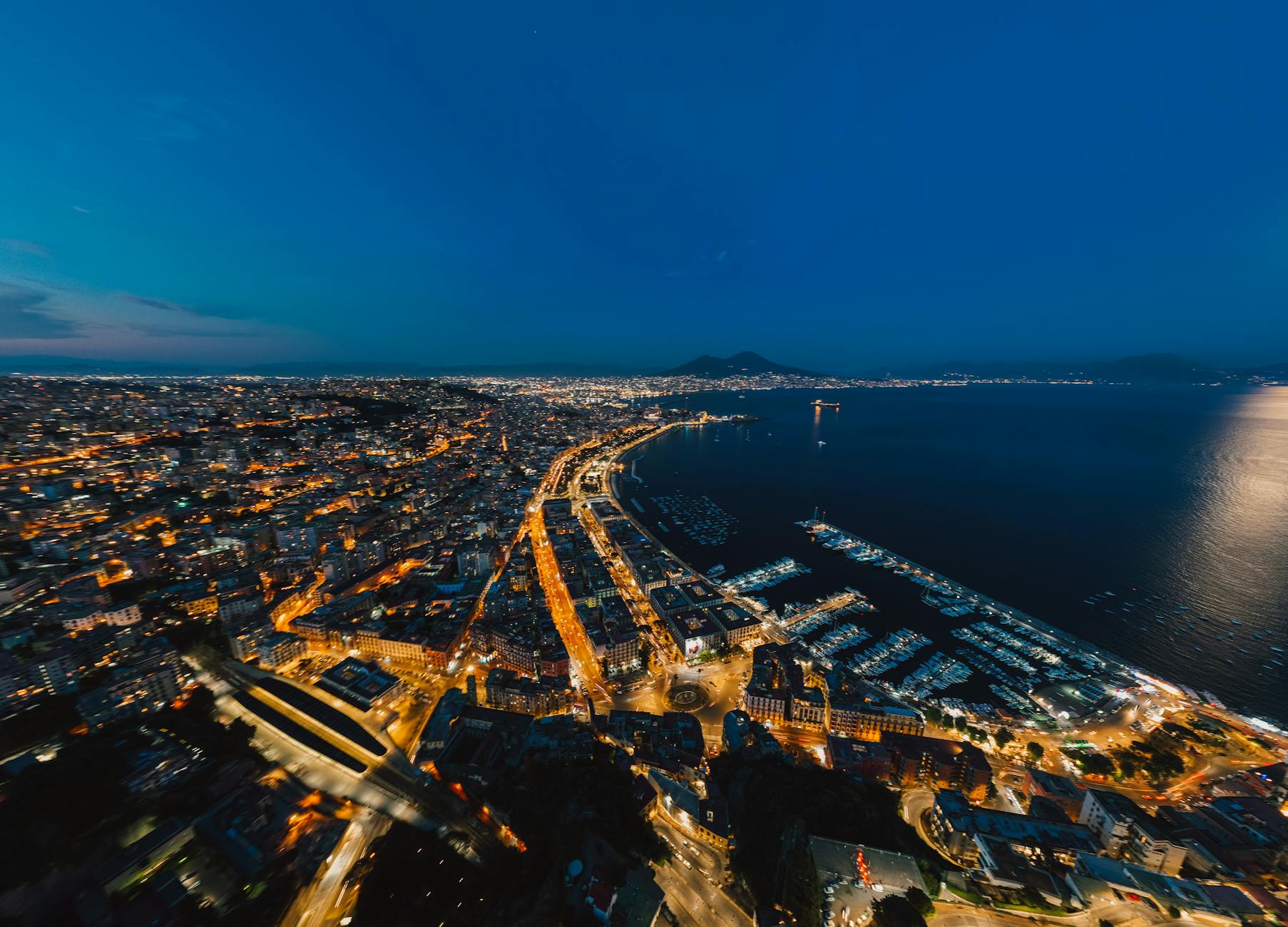 Night aerial view of Naples waterfront and city lights