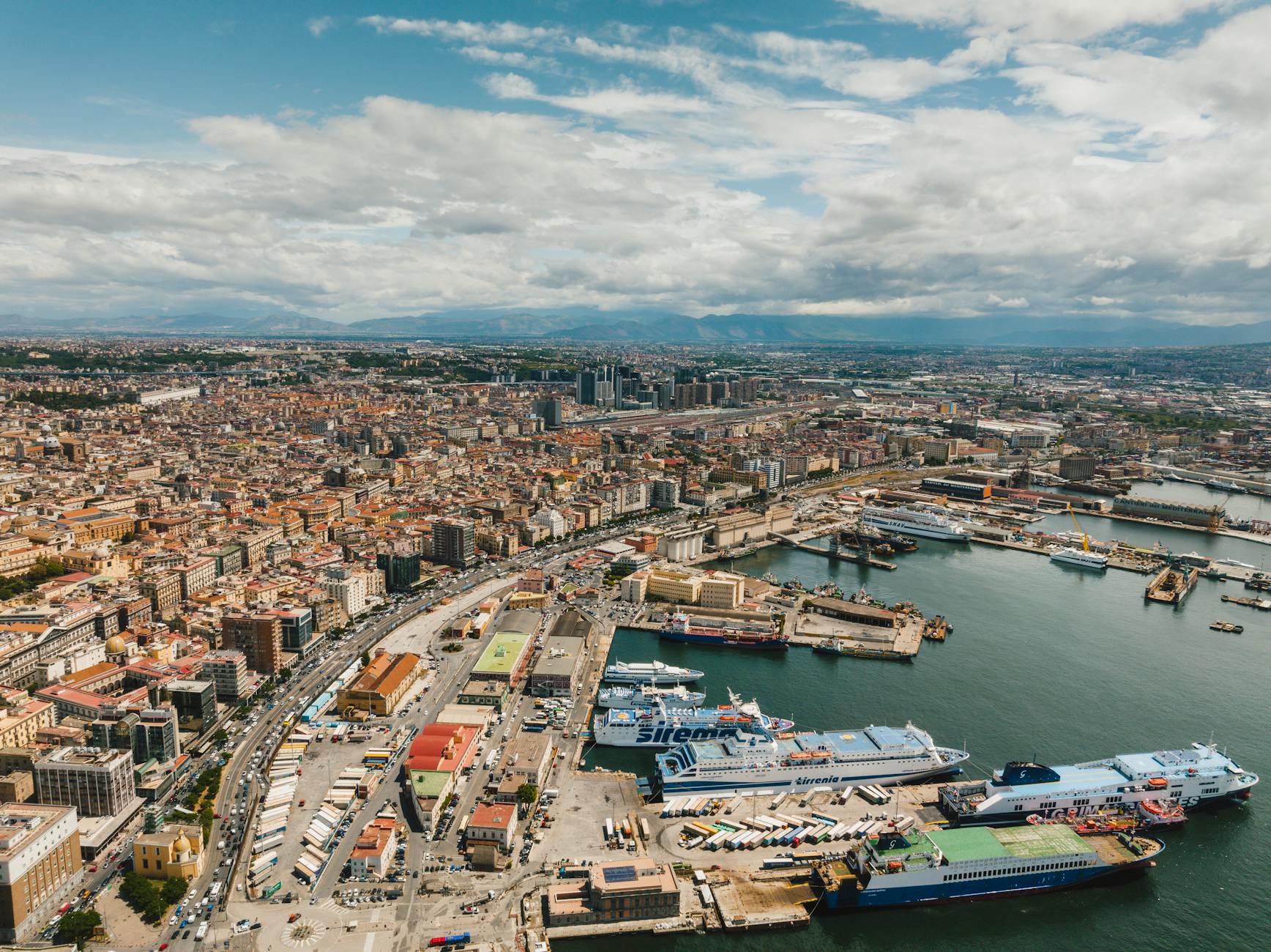 Aerial view of Naples harbor with ships and cityscape